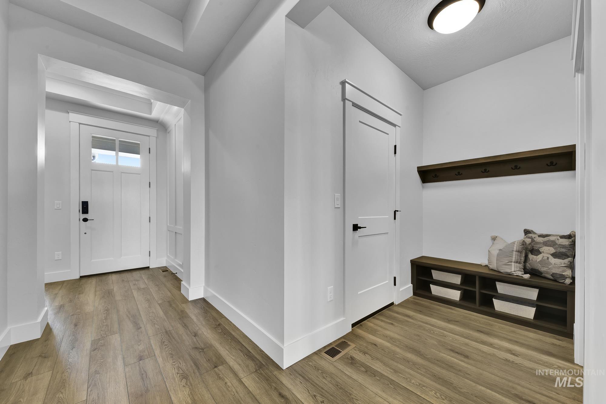 Entryway with baseboards and light wood-style flooring