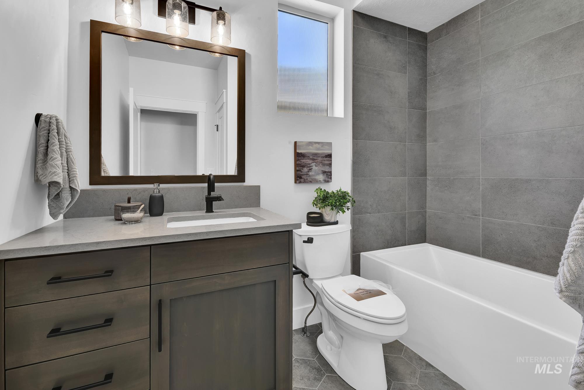 Full bathroom featuring vanity and tile patterned flooring