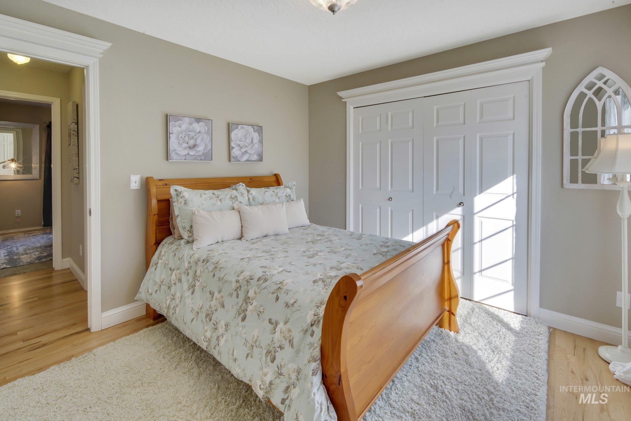 Bedroom with light wood-style flooring and a closet