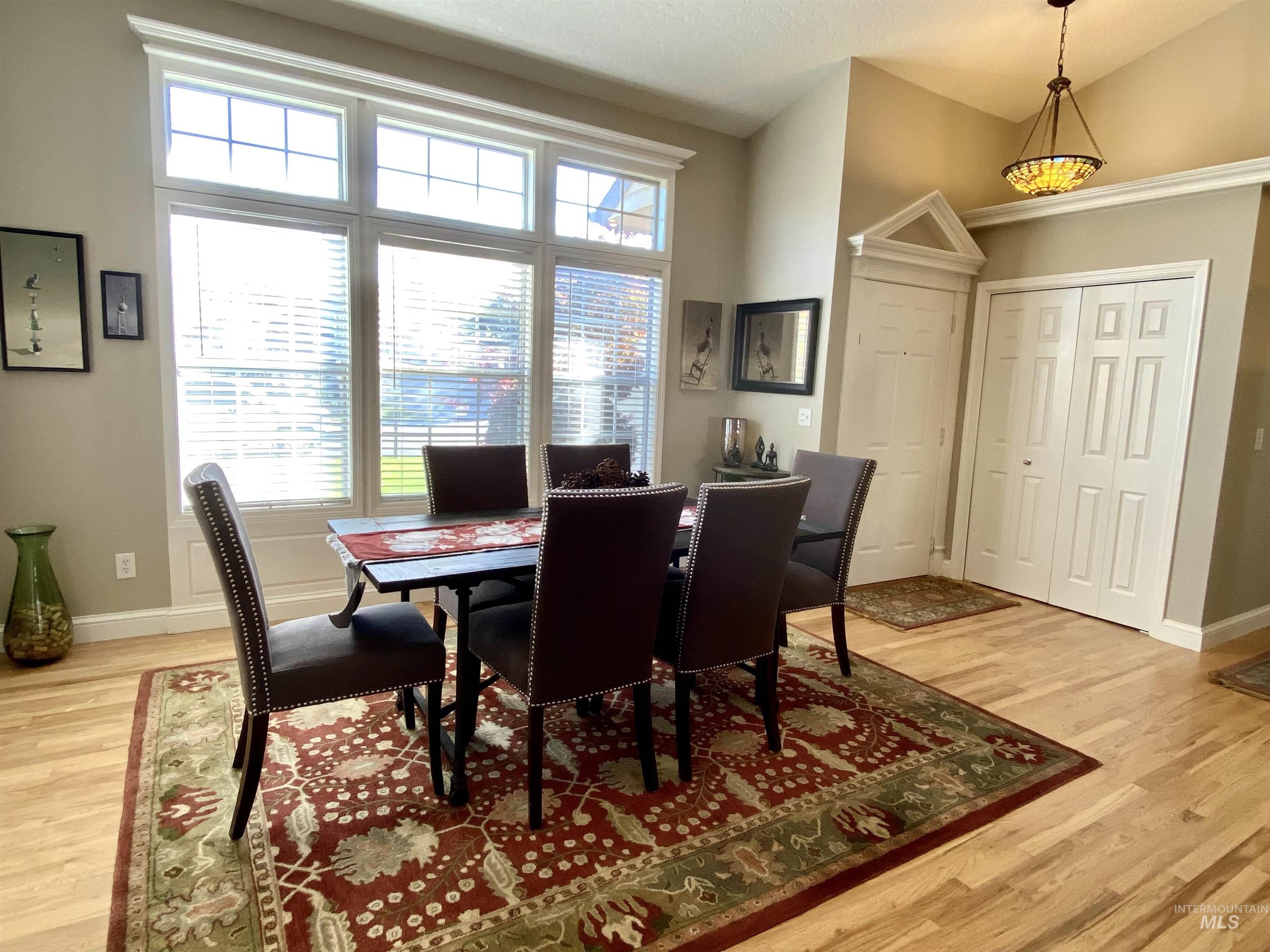 Dining area with light wood finished floors and baseboards