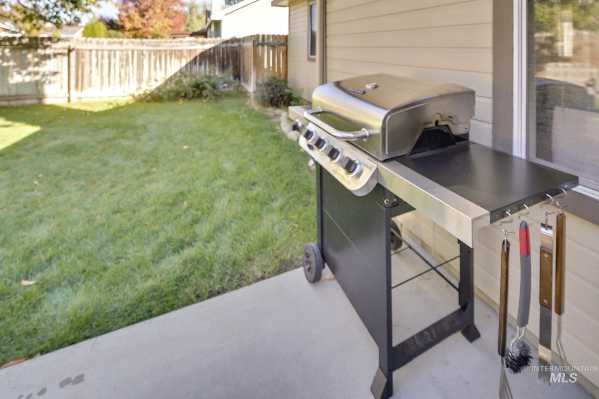 Fenced backyard with a patio area