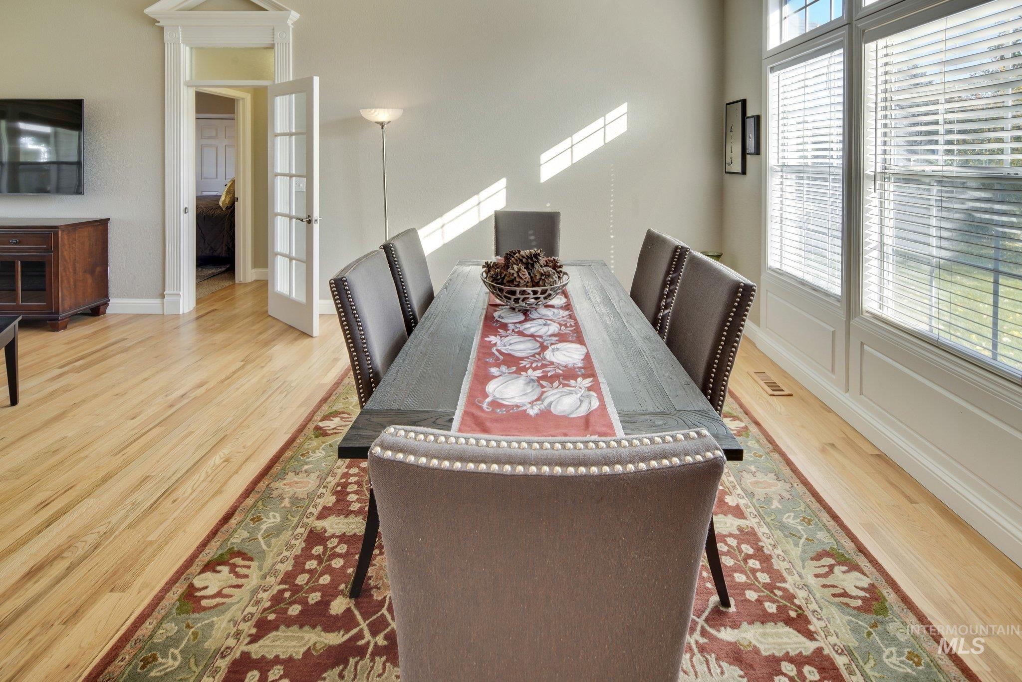 Dining space with light wood finished floors and french doors