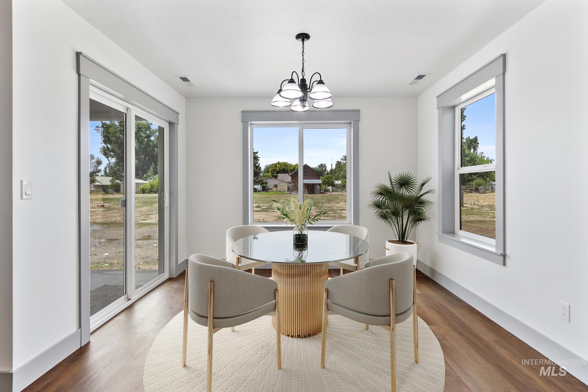 Dining room featuring wood finished floors and a chandelier