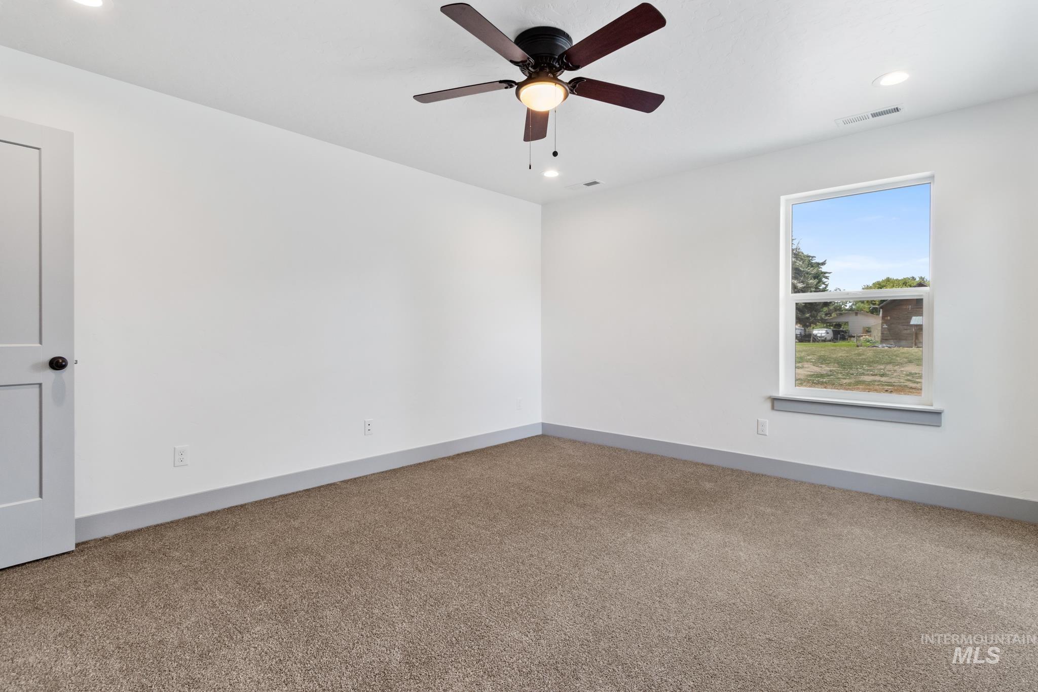 Spare room with recessed lighting, light colored carpet, and a ceiling fan