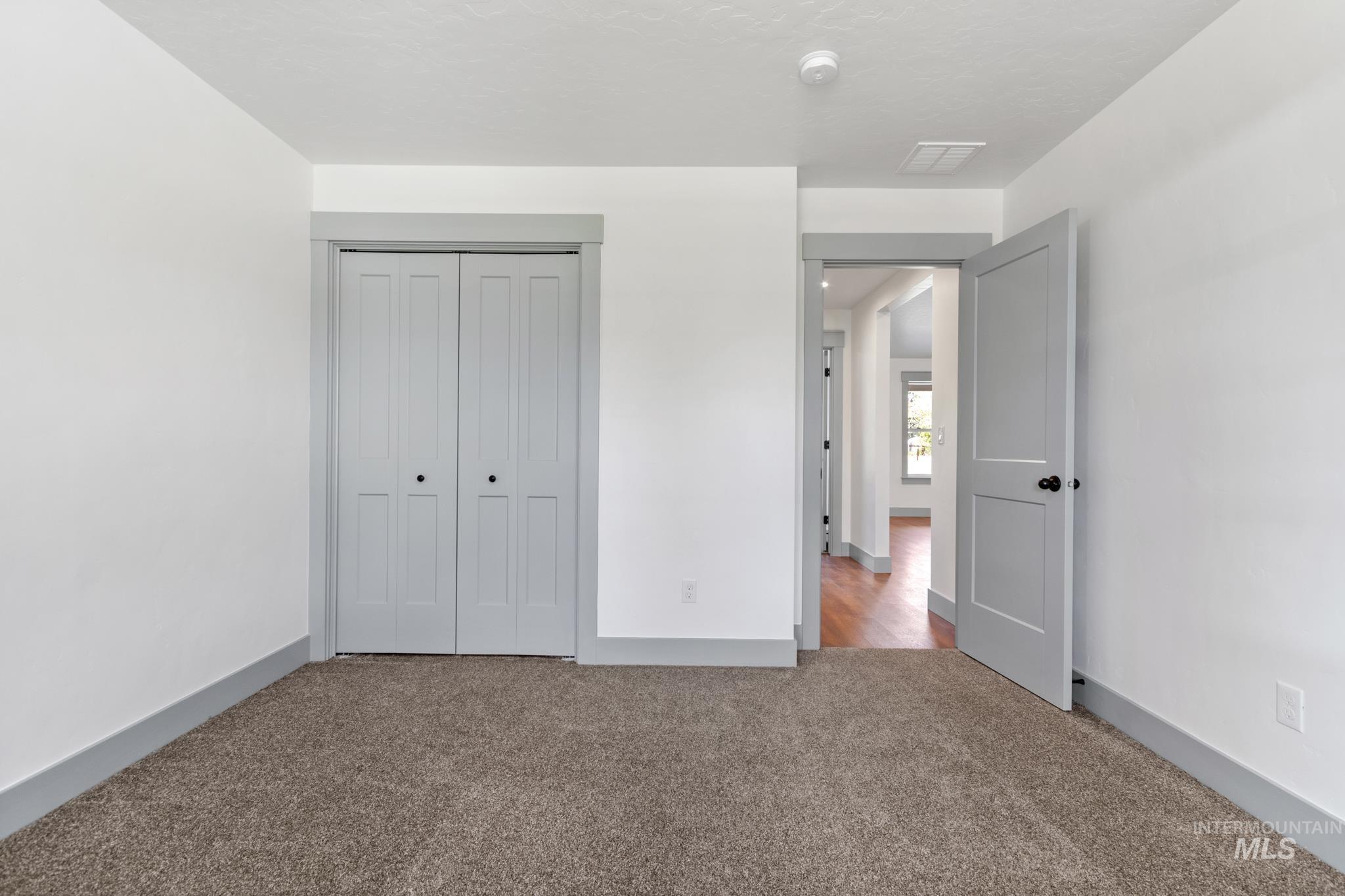 Unfurnished bedroom with carpet floors and a closet
