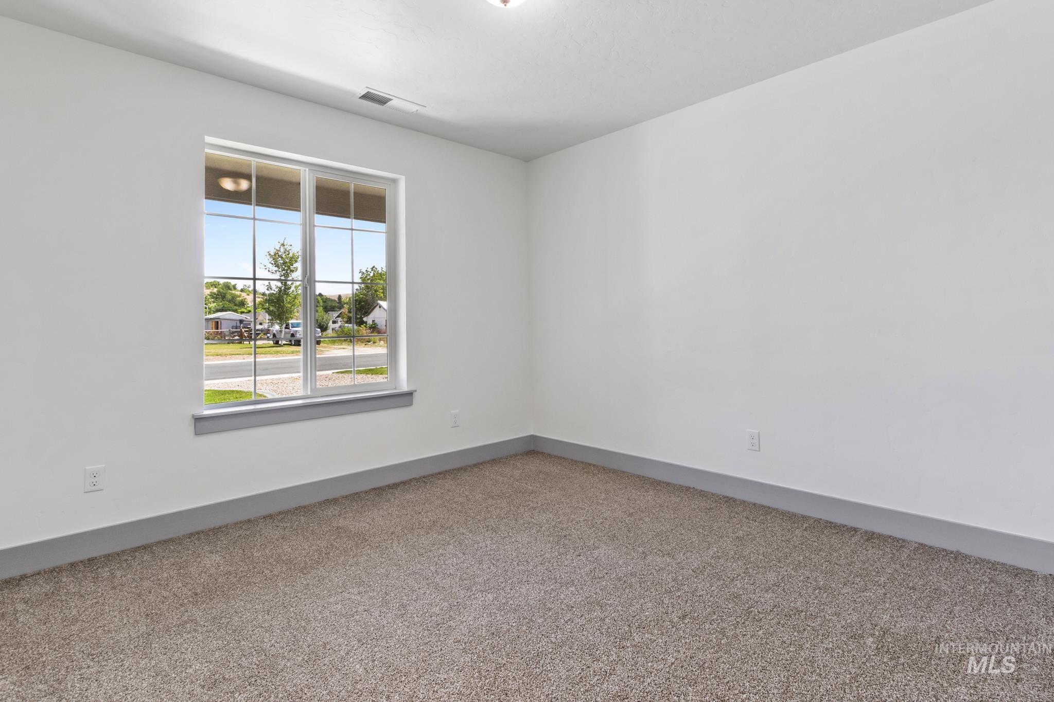 Unfurnished room with baseboards and carpet