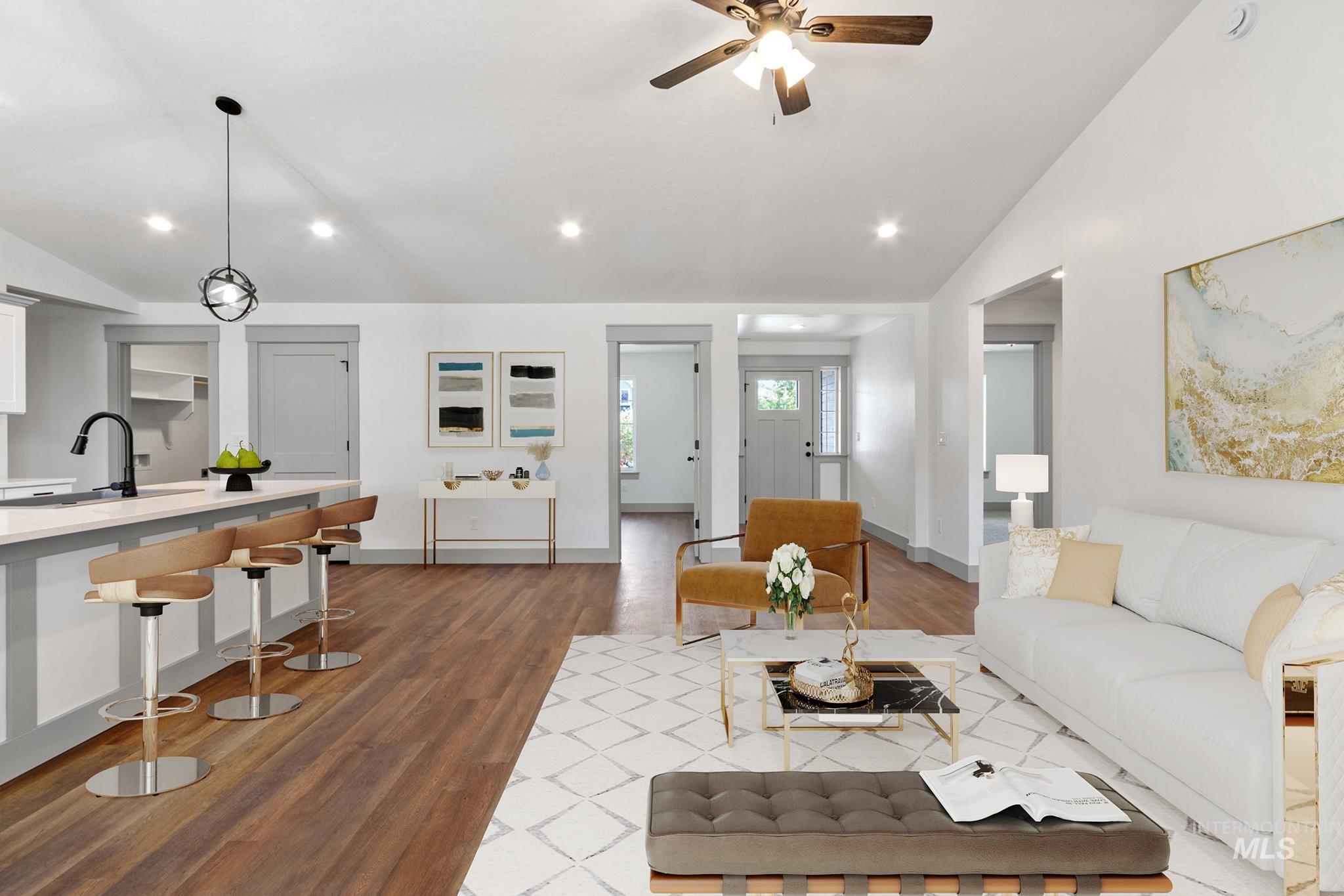 Living area with lofted ceiling, dark wood-type flooring, recessed lighting, and a ceiling fan