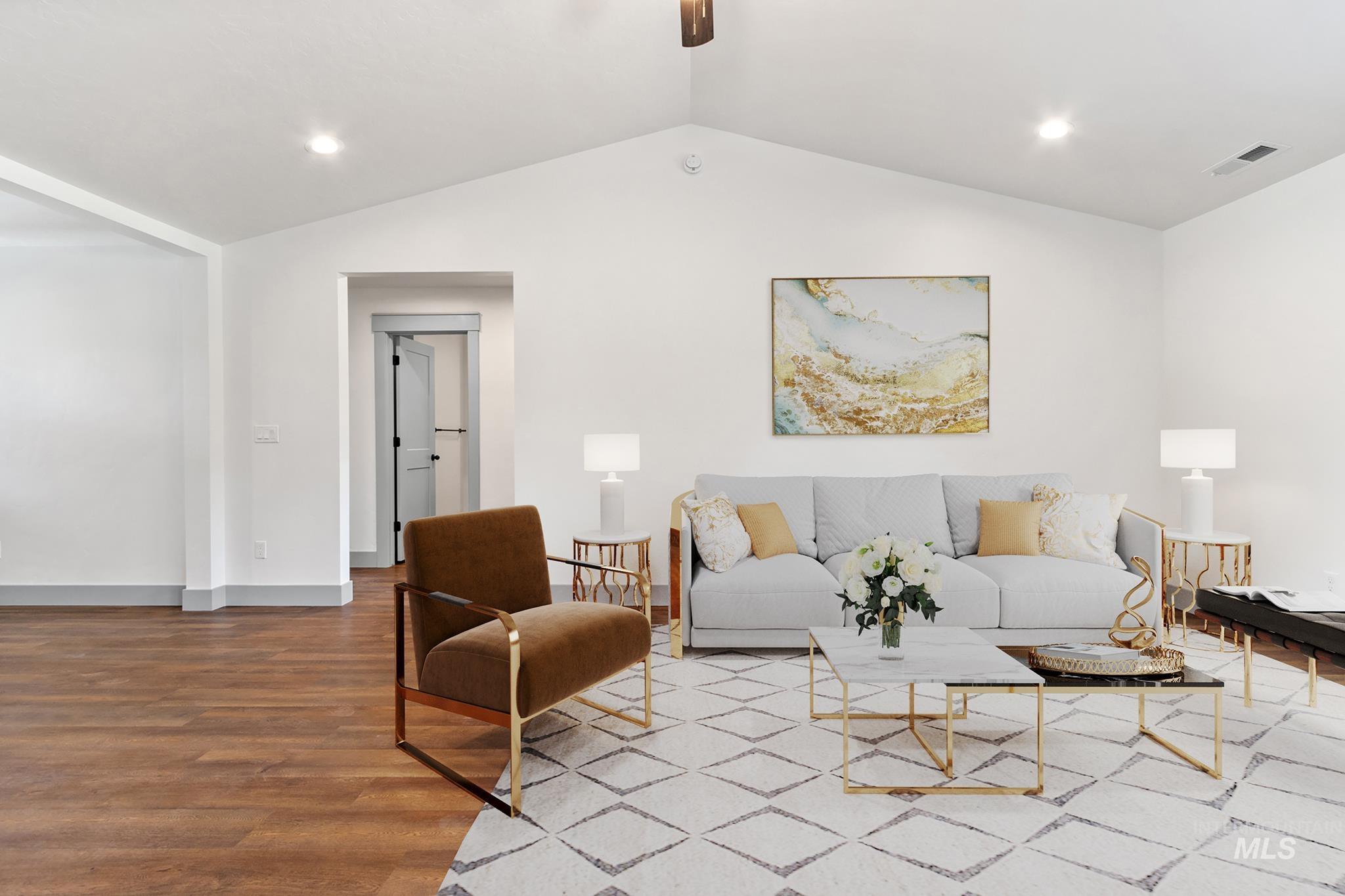 Living room with wood finished floors, vaulted ceiling, recessed lighting, and a ceiling fan