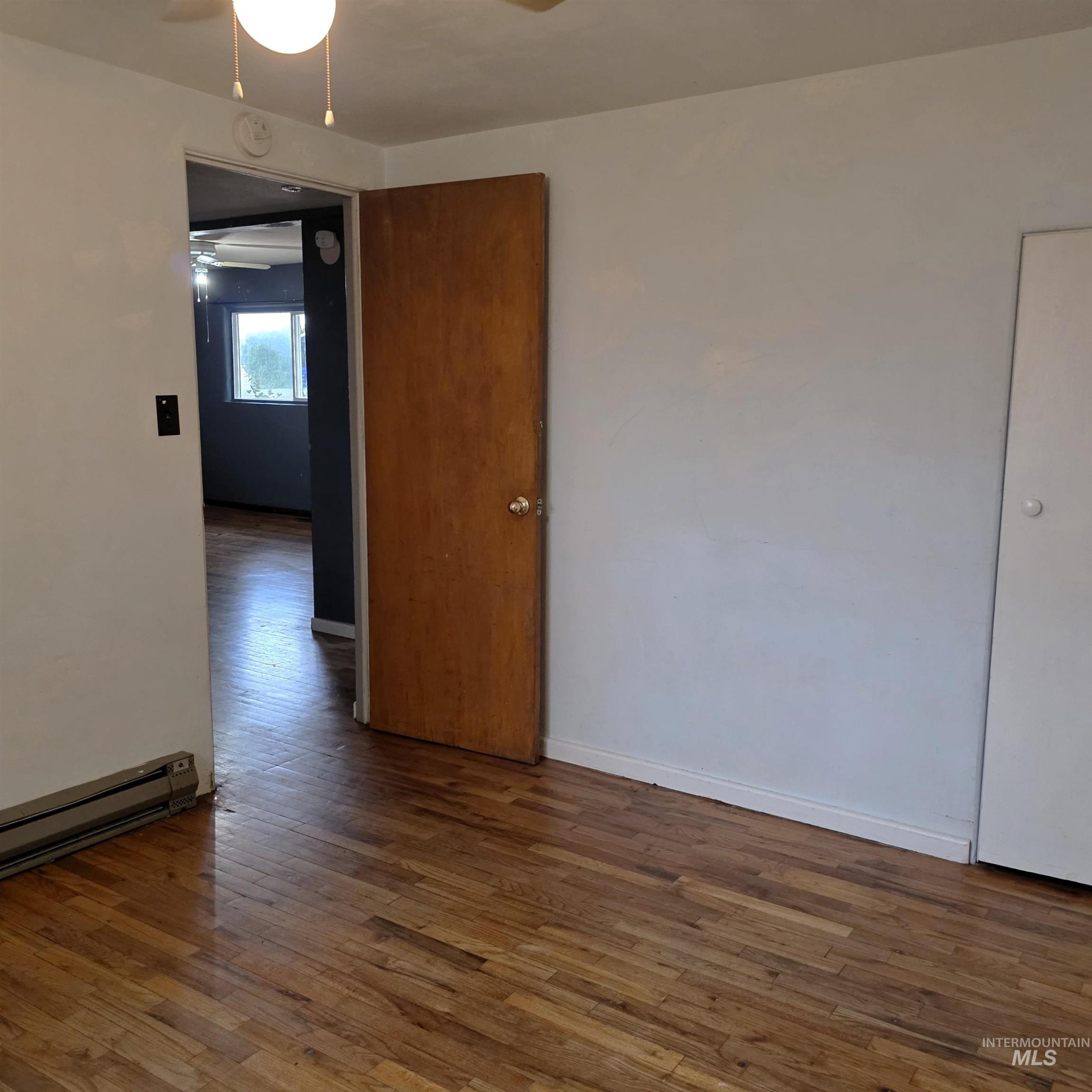 Unfurnished room featuring wood-type flooring and ceiling fan