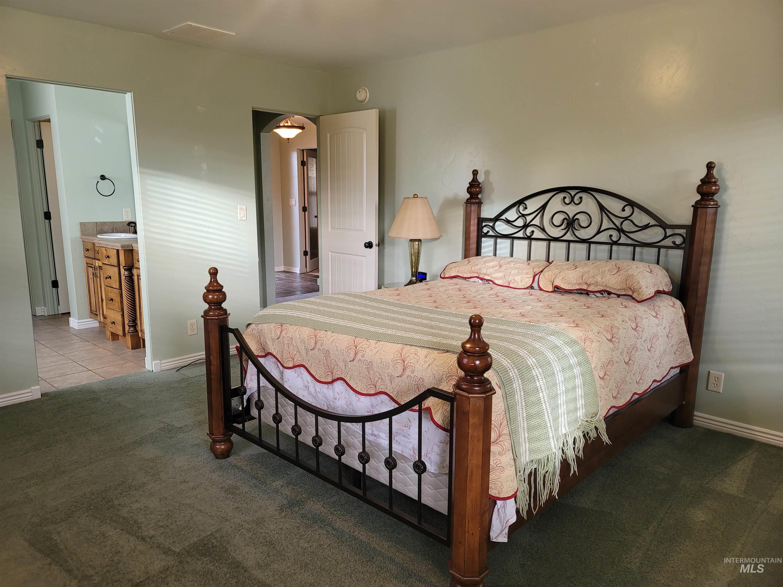 Bedroom featuring baseboards and carpet floors