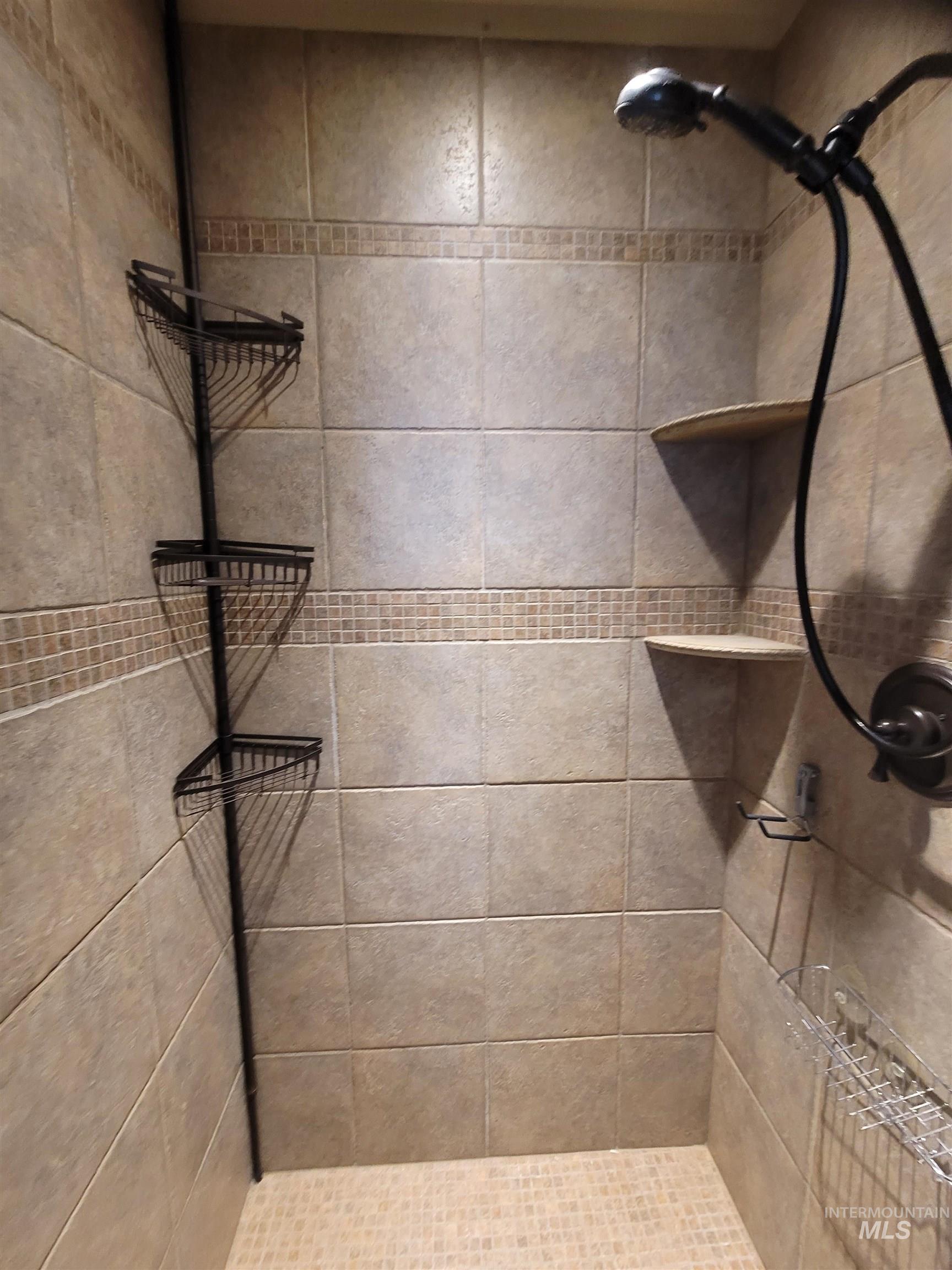 Full bathroom featuring tiled shower