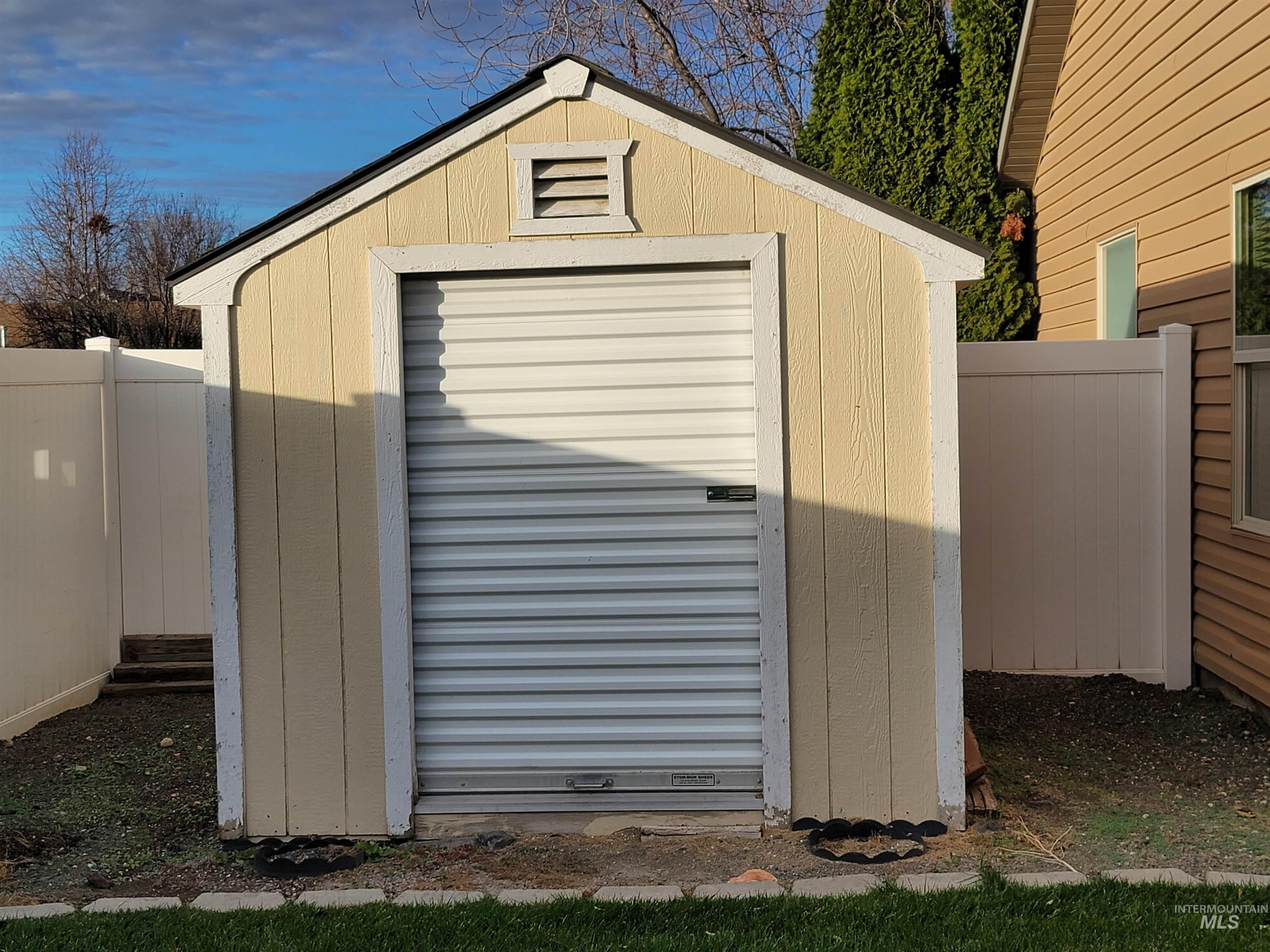View of shed with a fenced backyard