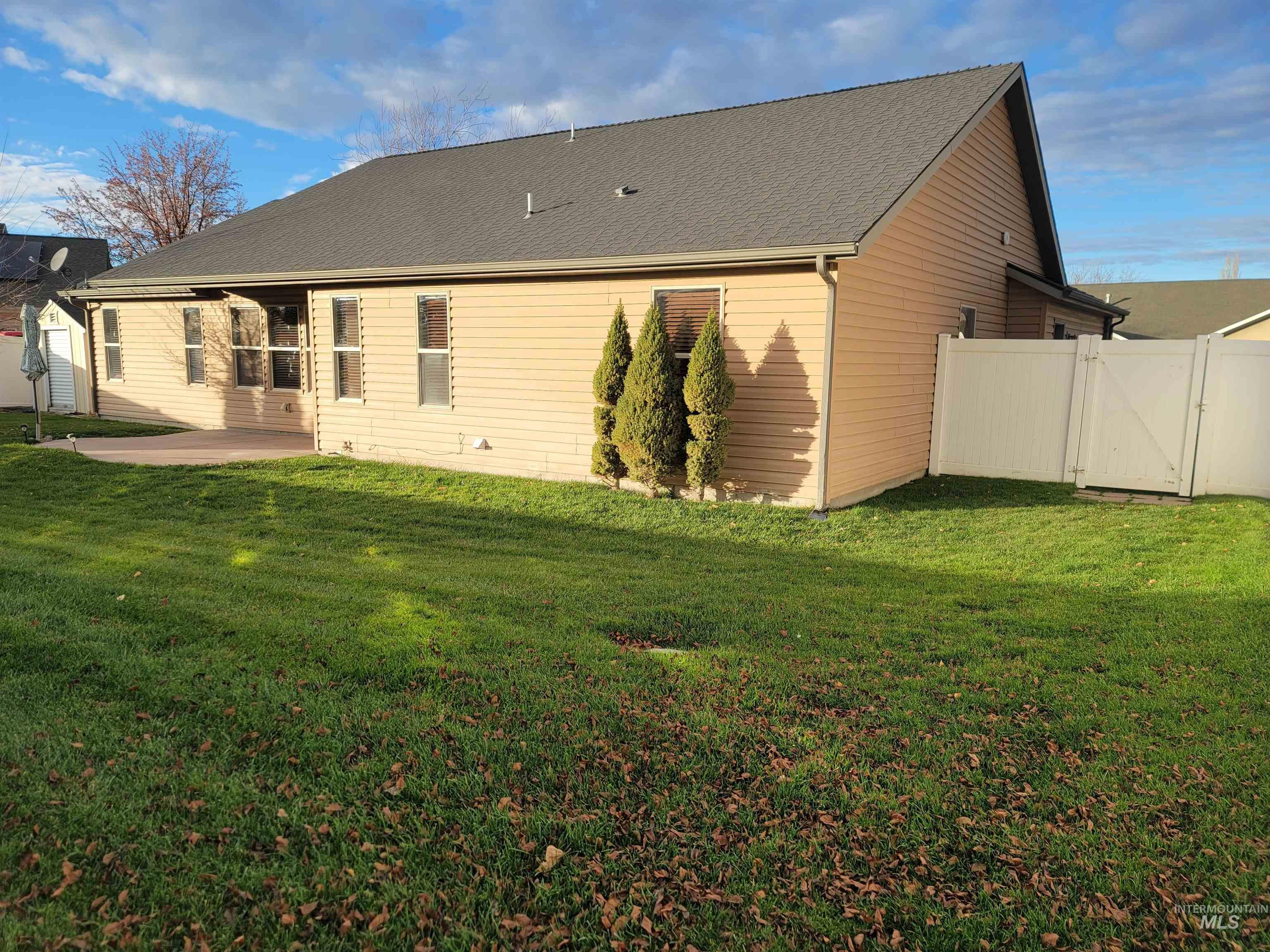 Rear view of property featuring a gate and a patio area