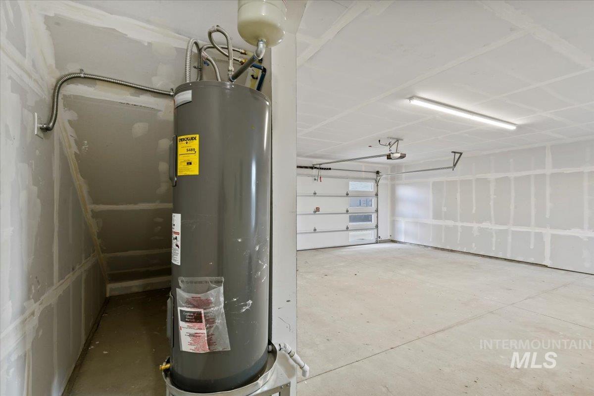 Garage with electric water heater and a garage door opener