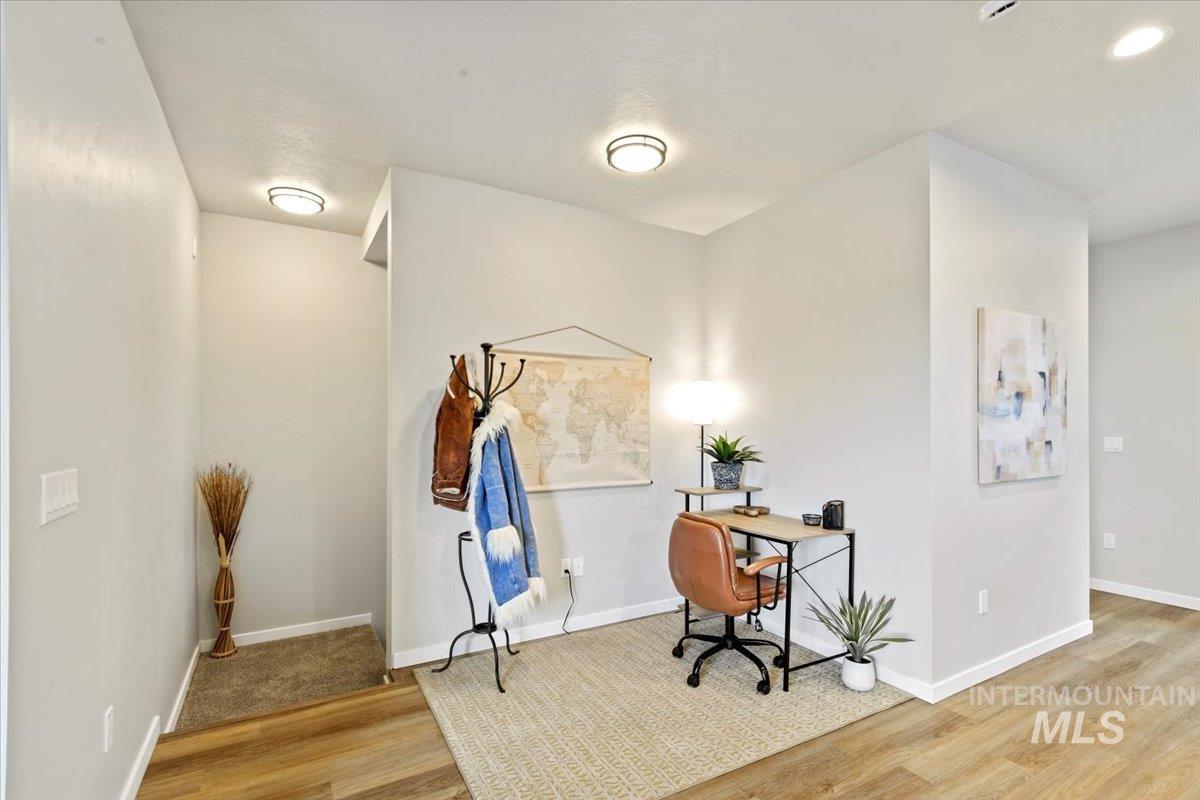 Home office with wood finished floors and baseboards