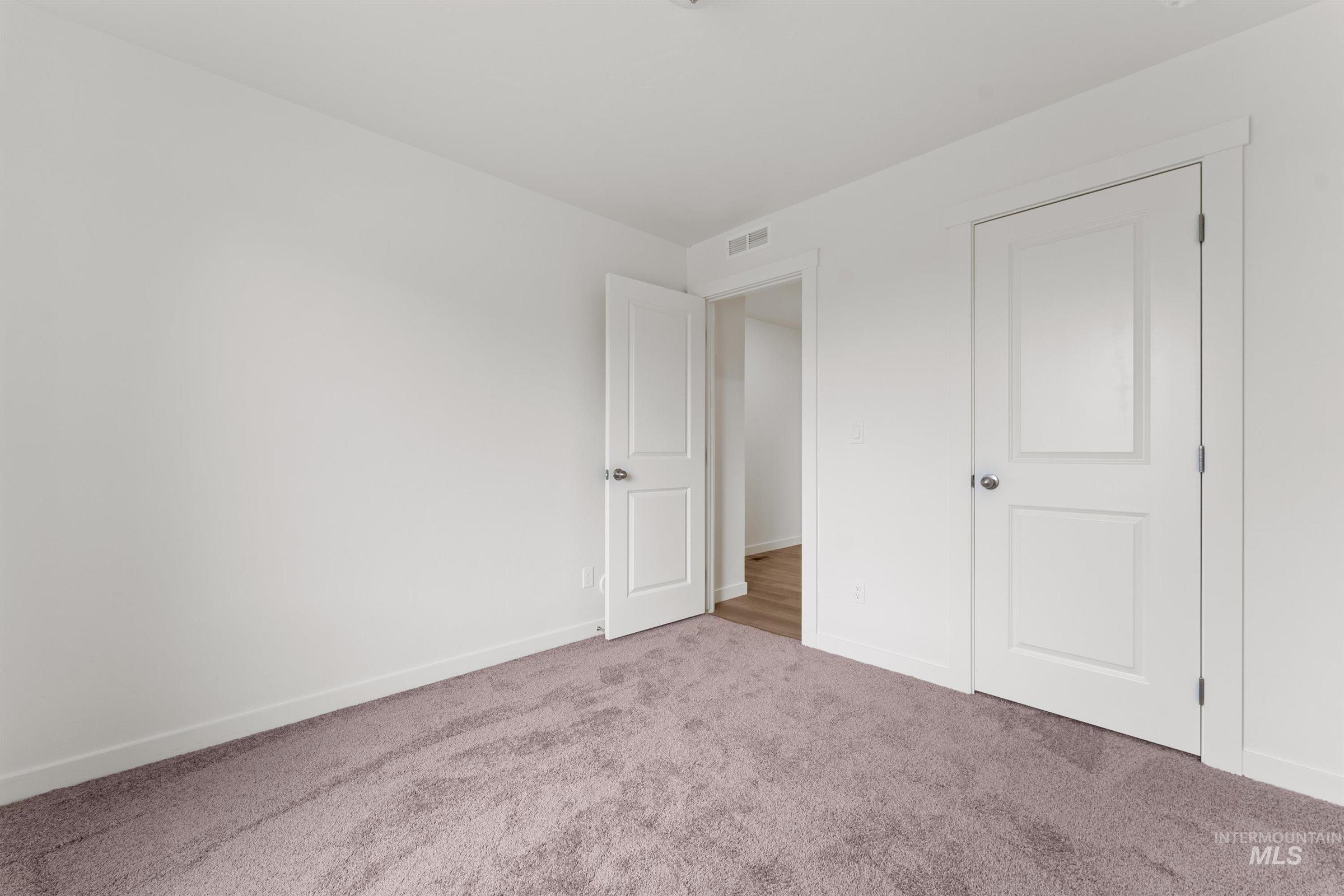 Unfurnished bedroom with baseboards and carpet floors
