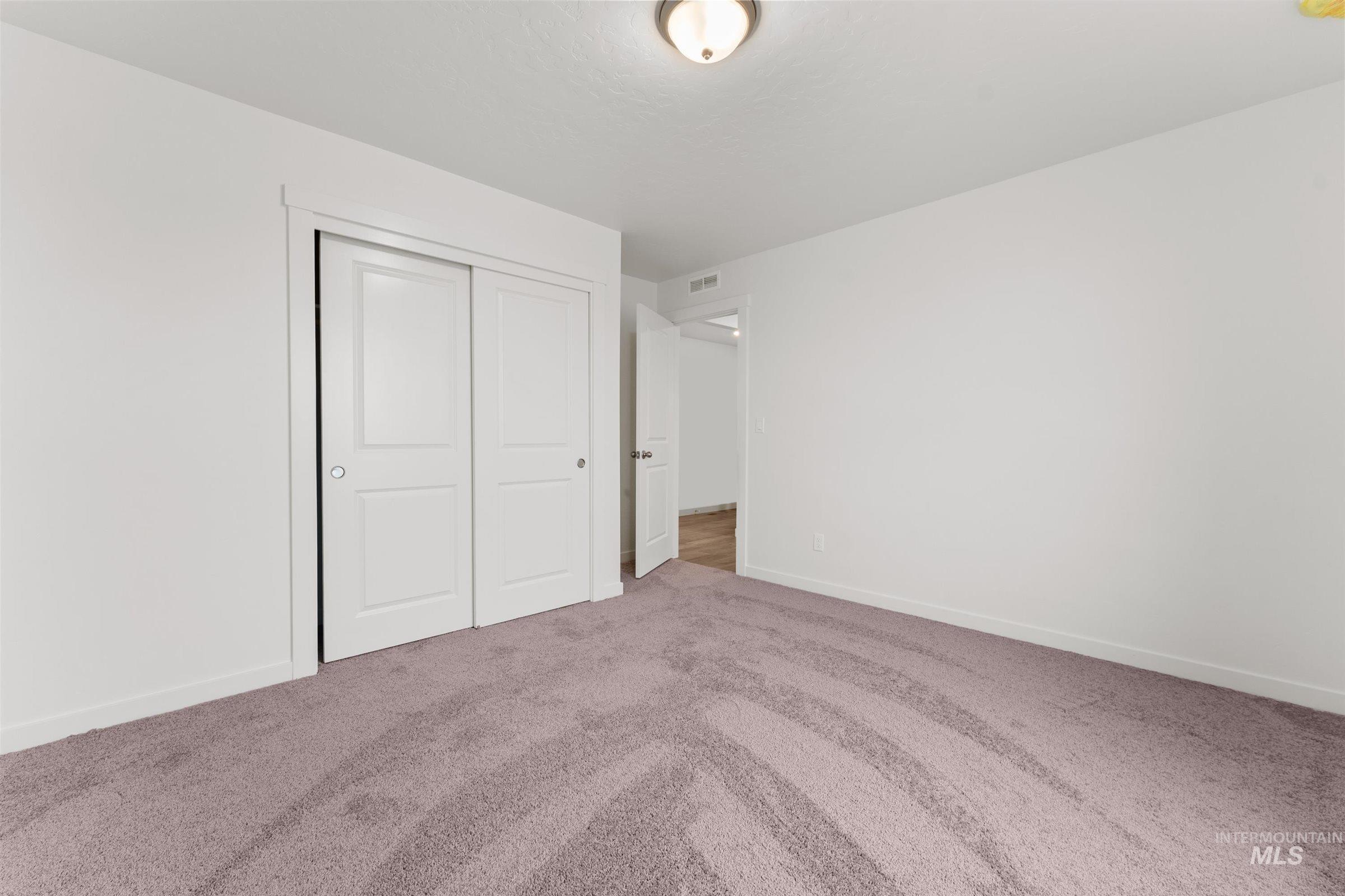 Unfurnished bedroom with carpet floors and a closet