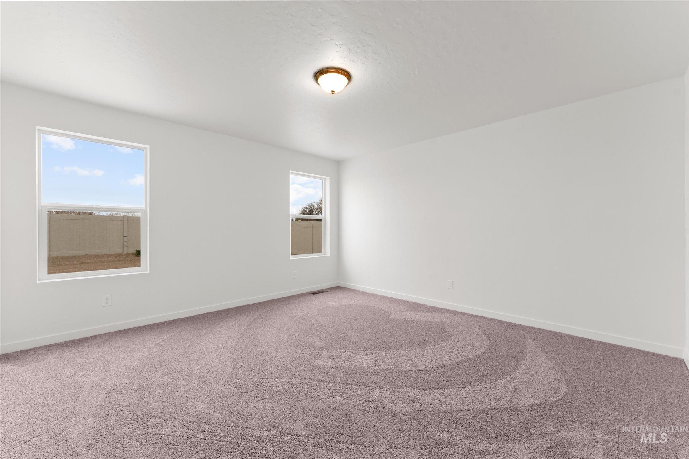 Unfurnished room with carpet and baseboards