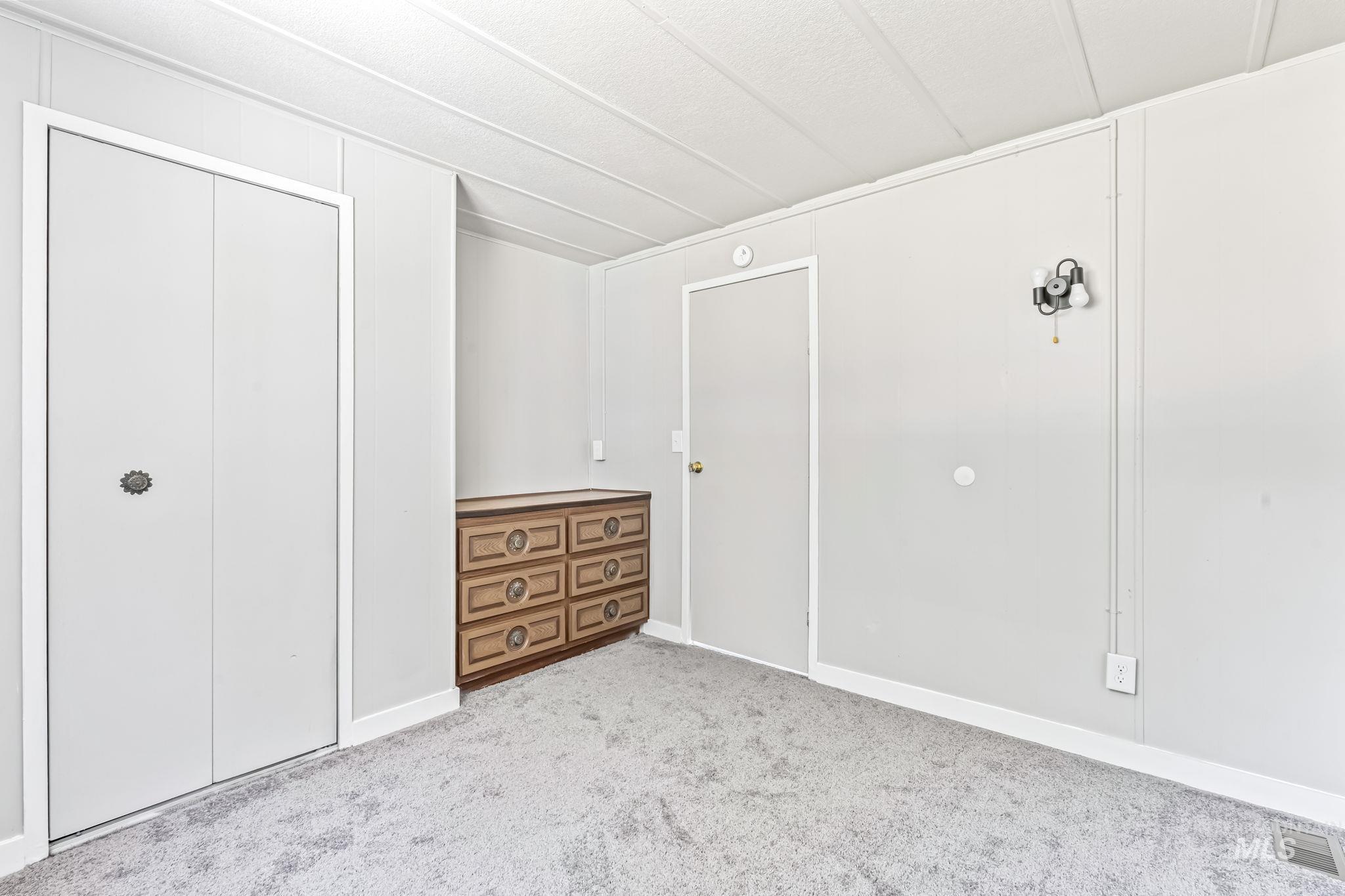 Unfurnished bedroom with carpet floors and a closet