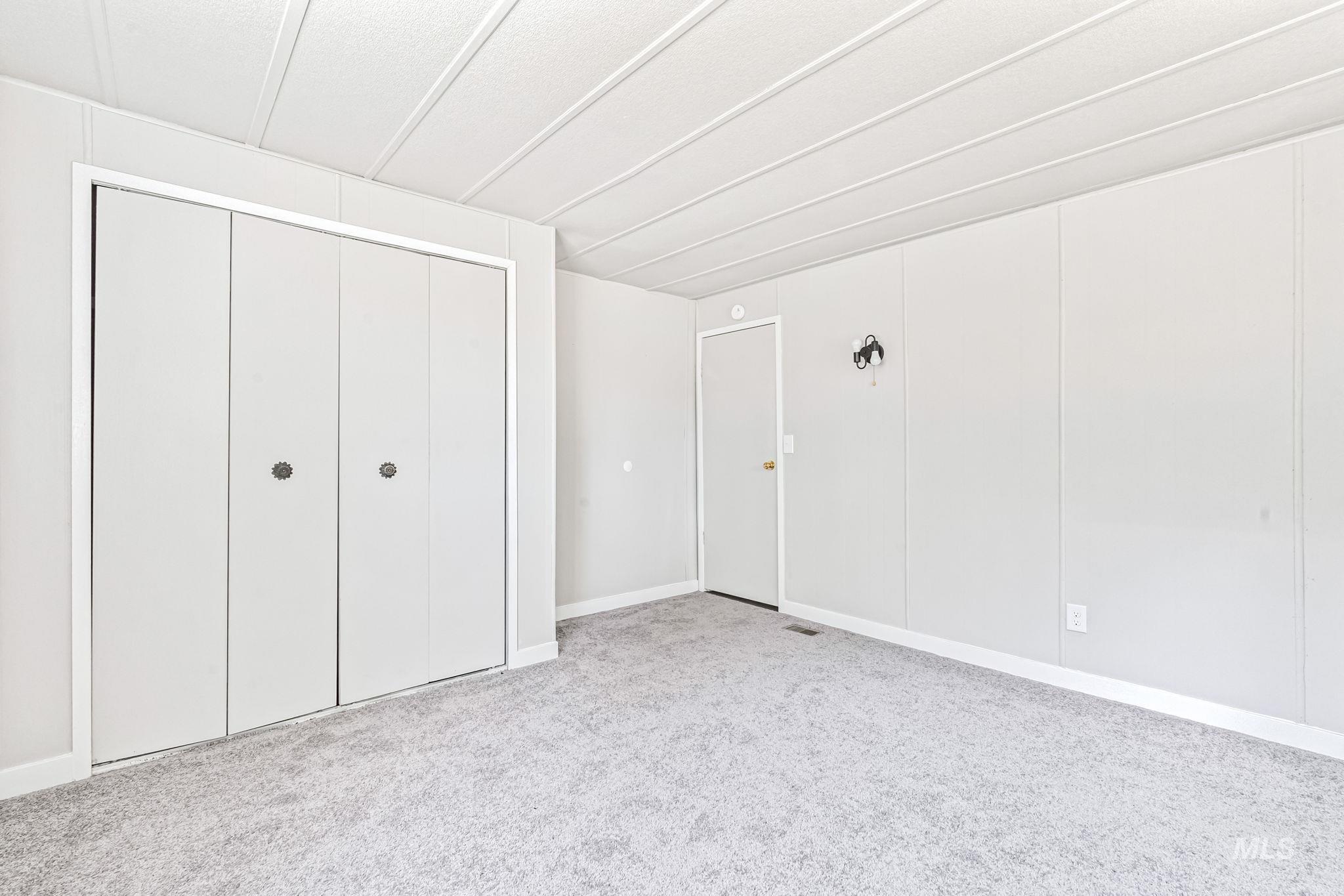 Unfurnished bedroom with carpet flooring