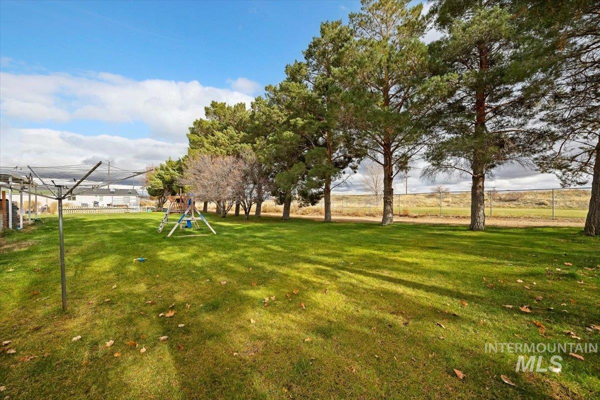 View of green lawn featuring a playground