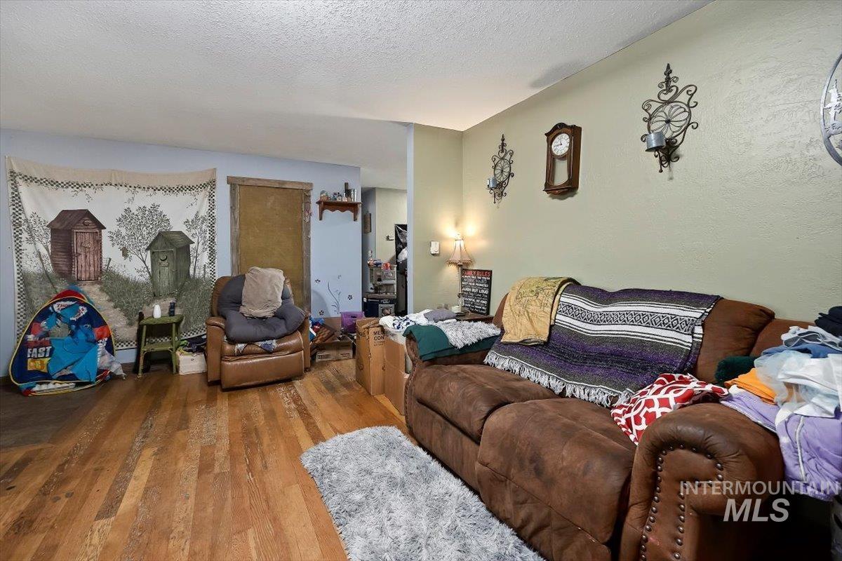 Living room with wood finished floors and a textured ceiling