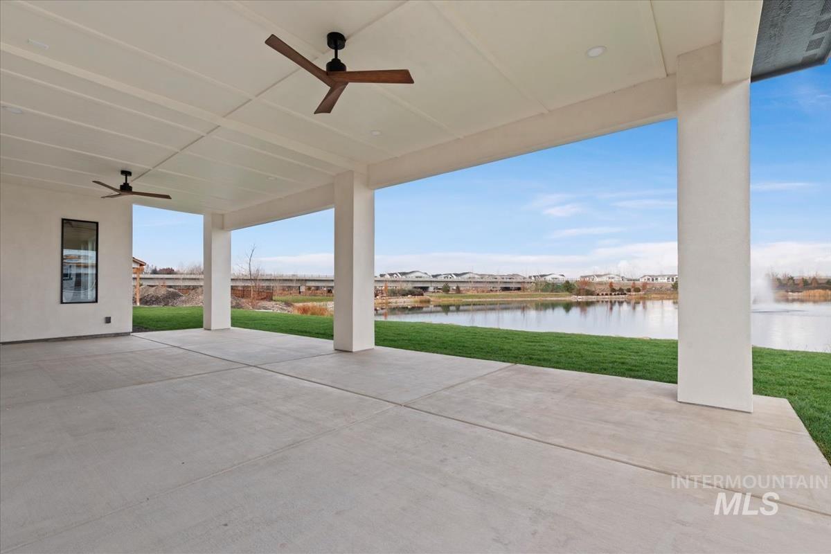 View of patio / terrace with ceiling fan and a water view