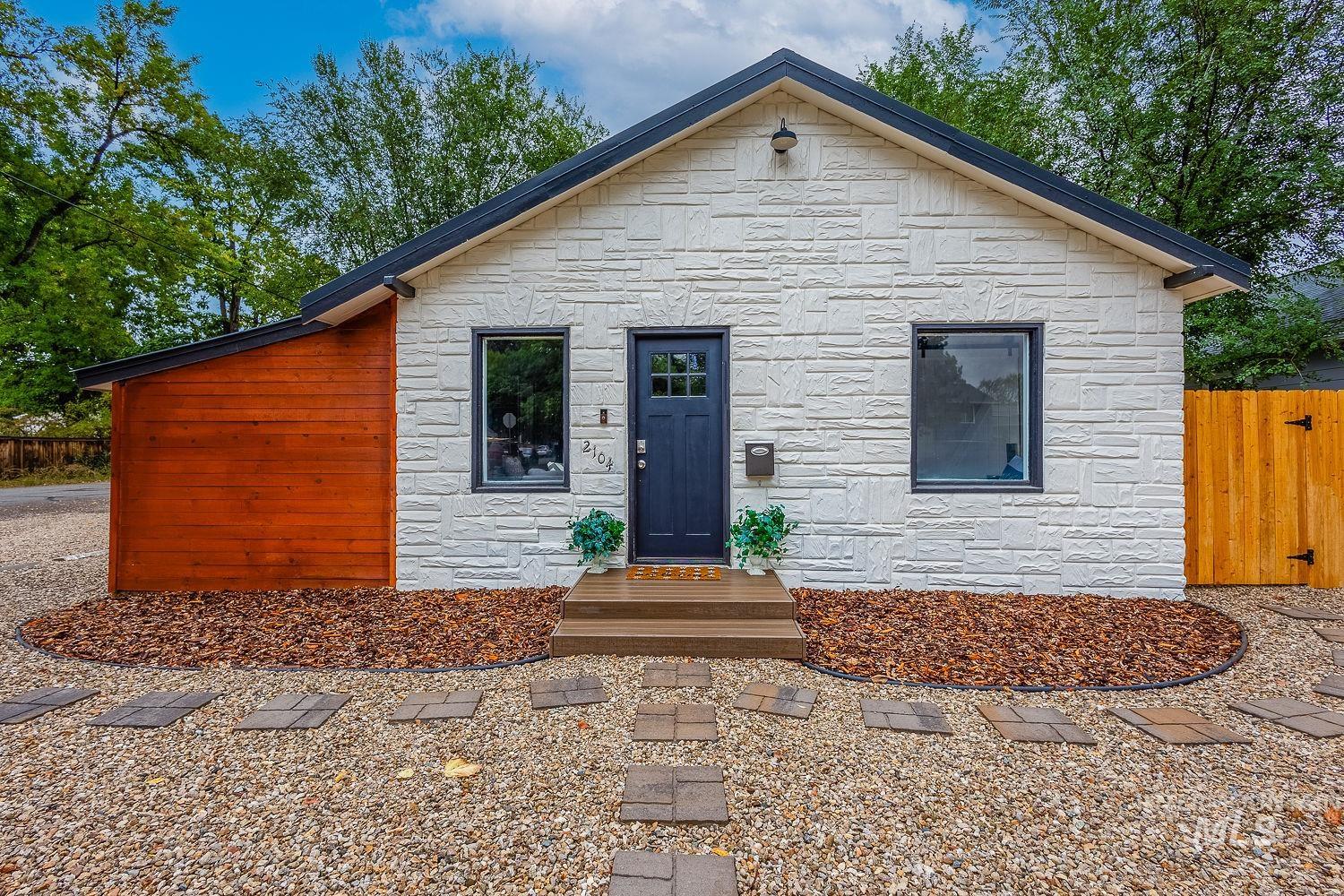 View of front of house with stone siding