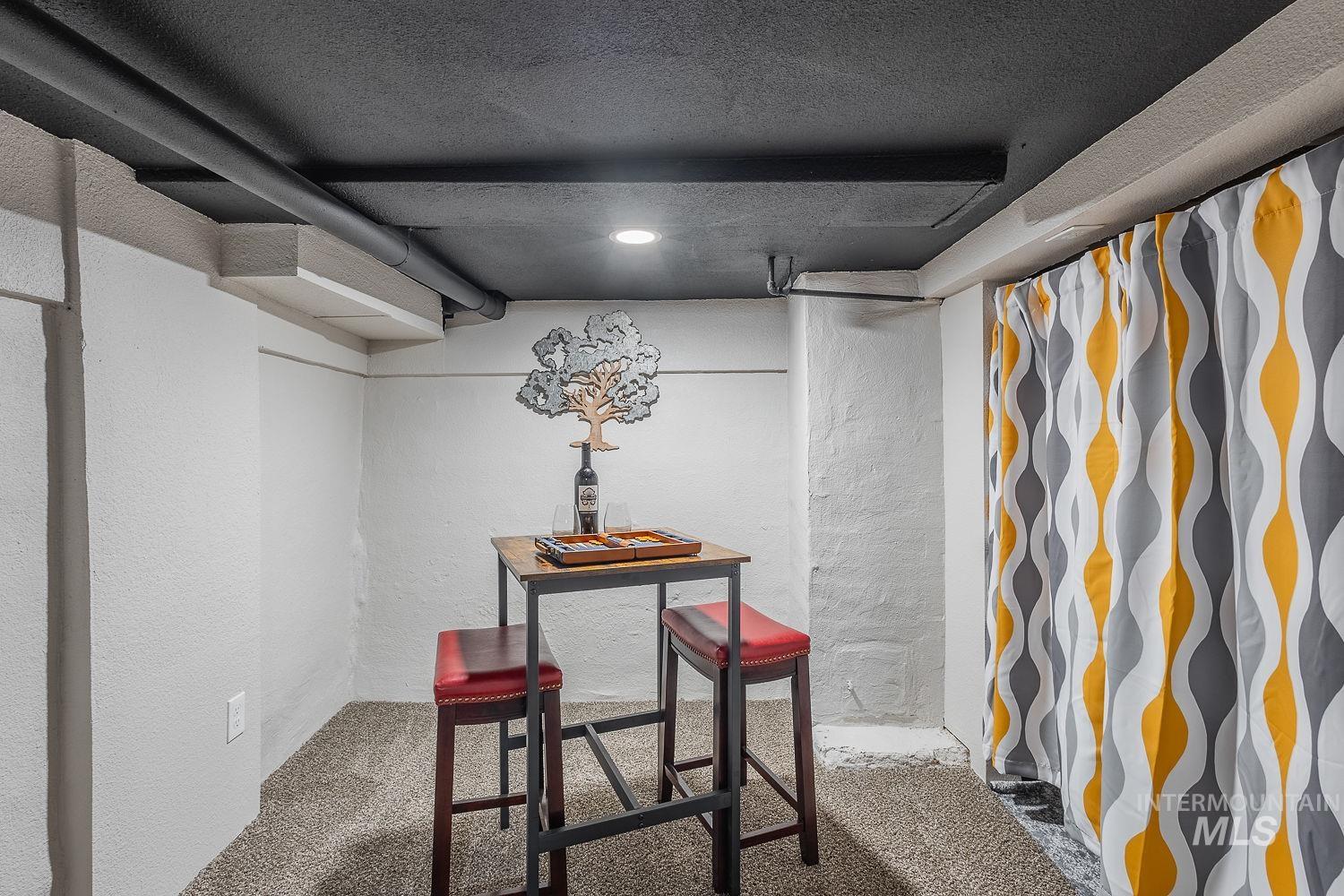Finished basement with a textured wall, carpet flooring, and a textured ceiling
