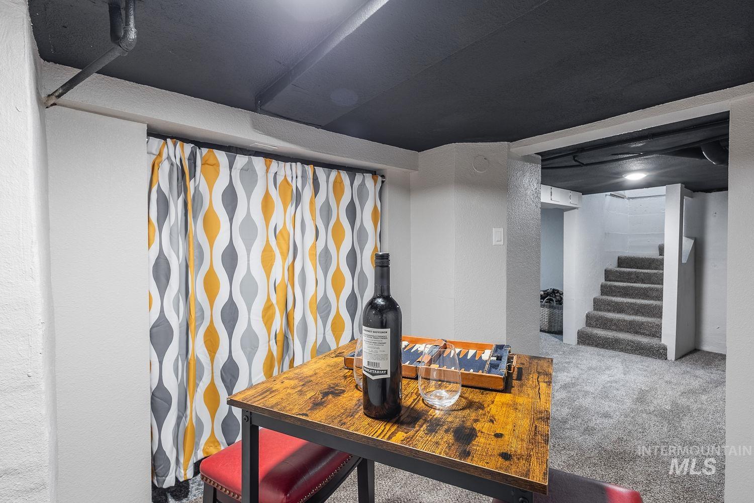 Detailed view of carpet flooring and a textured wall