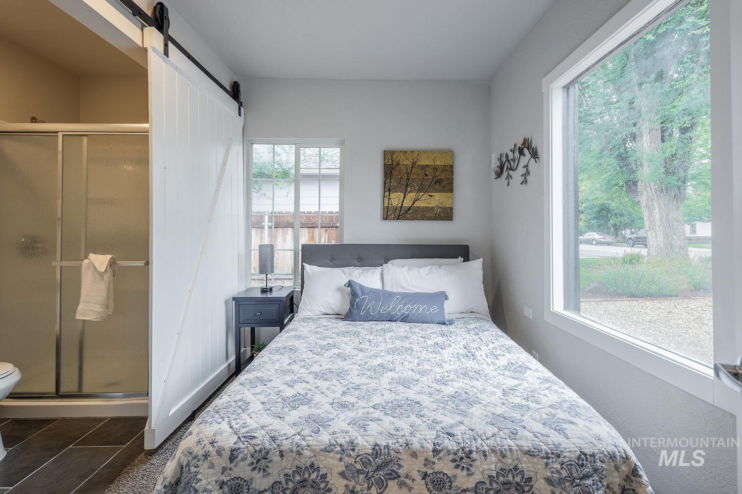 Bedroom featuring a barn door and a closet
