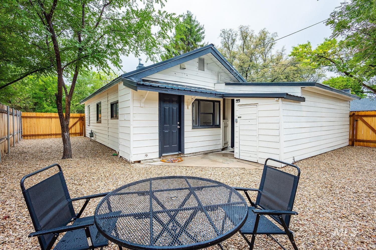 Rear view of property with a fenced backyard, a patio, and outdoor dining area
