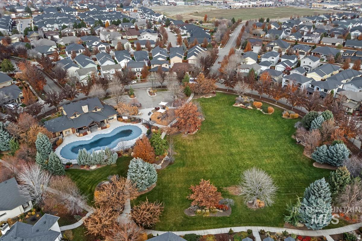Aerial view of property's location featuring nearby suburban area and a pool area