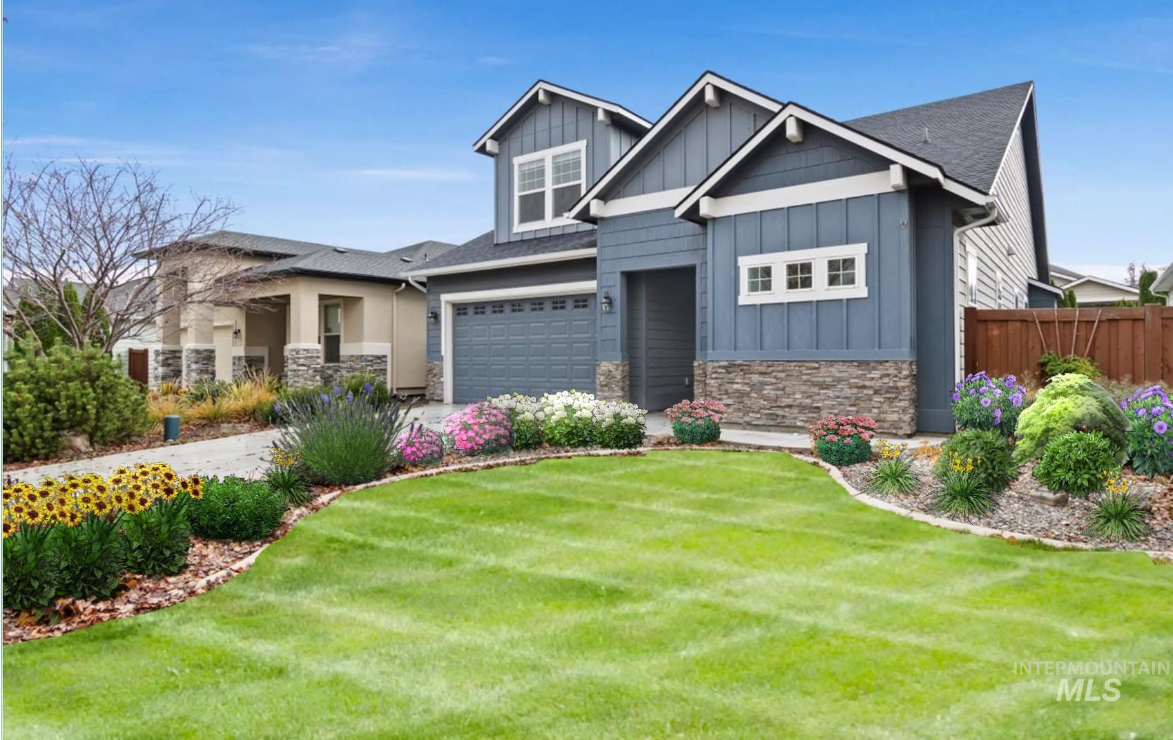 Craftsman-style home featuring stone siding, board and batten siding, an attached garage, and driveway