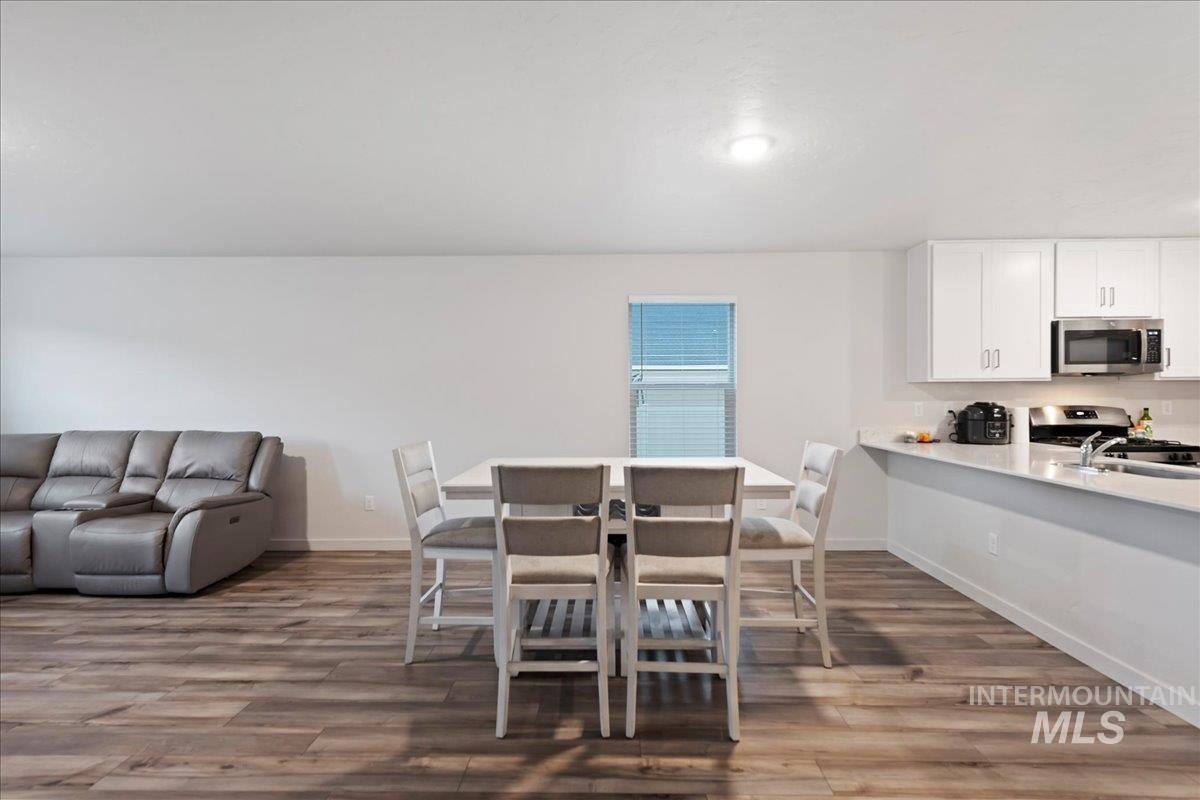 Dining room with dark wood-type flooring