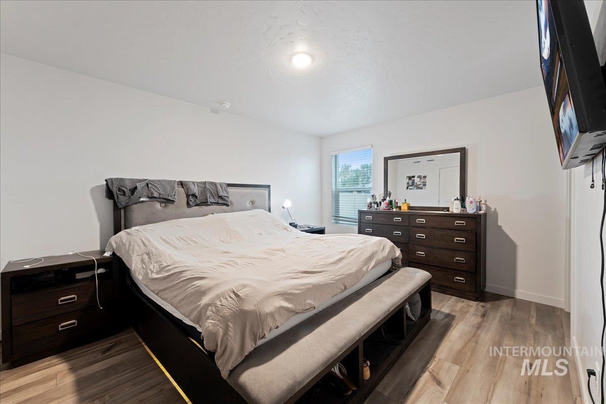 Bedroom featuring light wood finished floors and baseboards