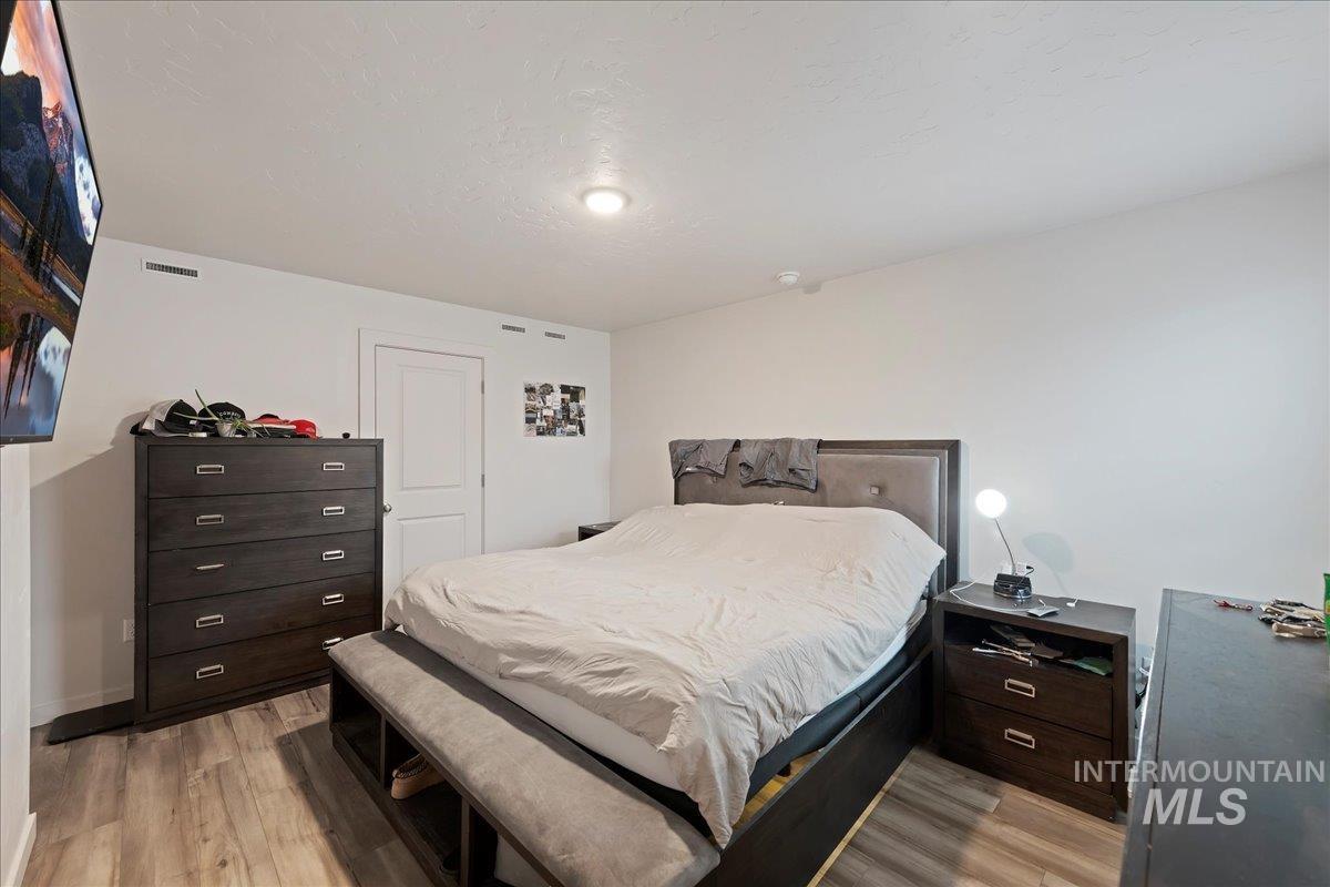 Bedroom with light wood-style floors and baseboards