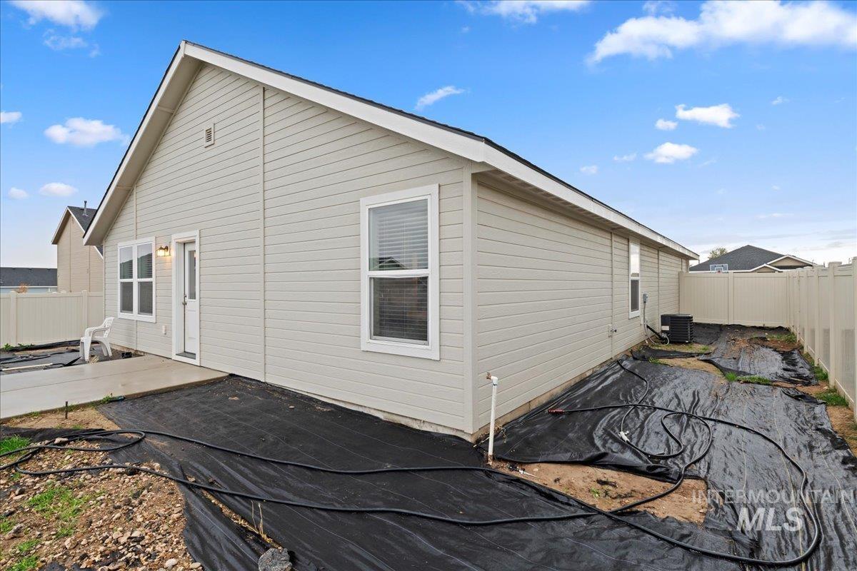 View of home's exterior with a fenced backyard and a patio area