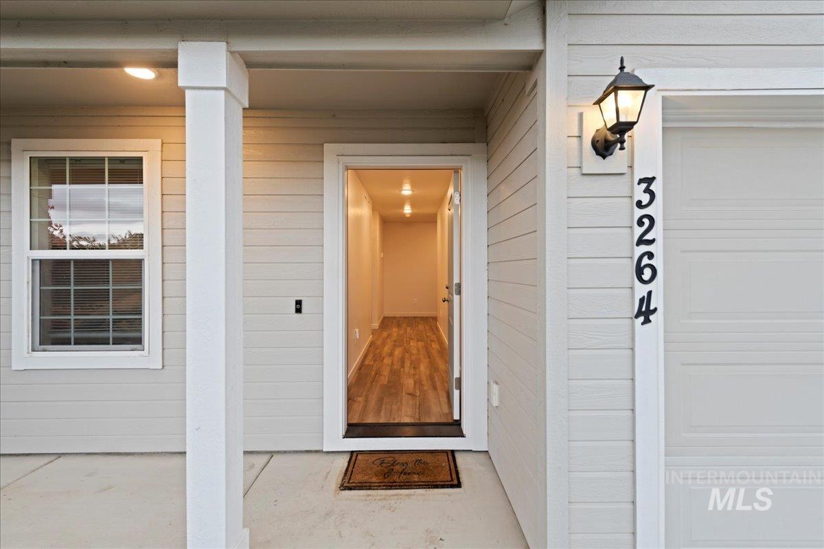 Doorway to property featuring a garage