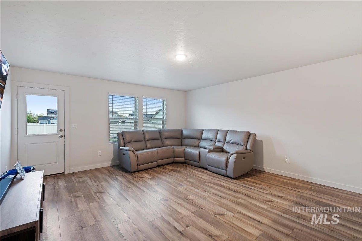 Living area with light wood-style floors and baseboards