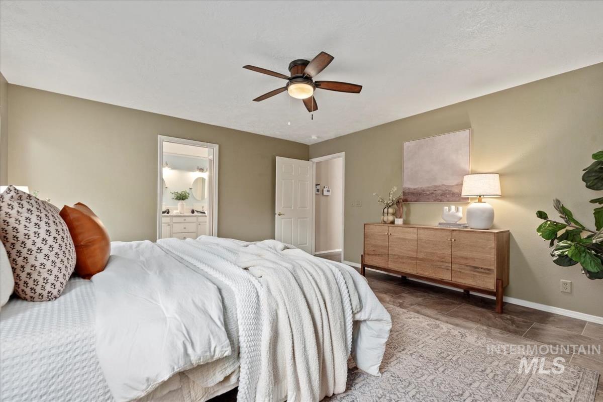 Bedroom with a ceiling fan and connected bathroom