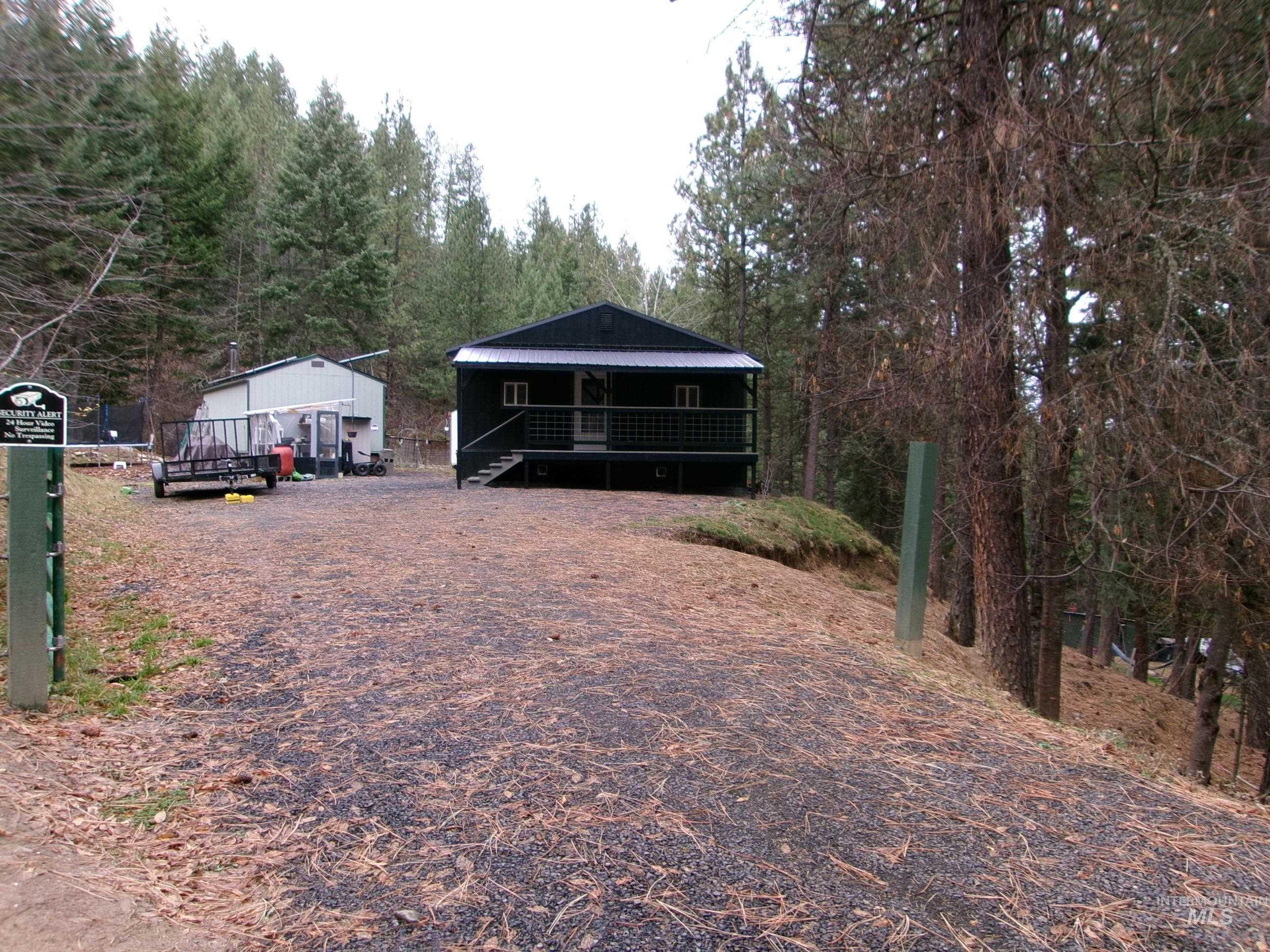 View of front of property featuring a metal roof and a wooden deck