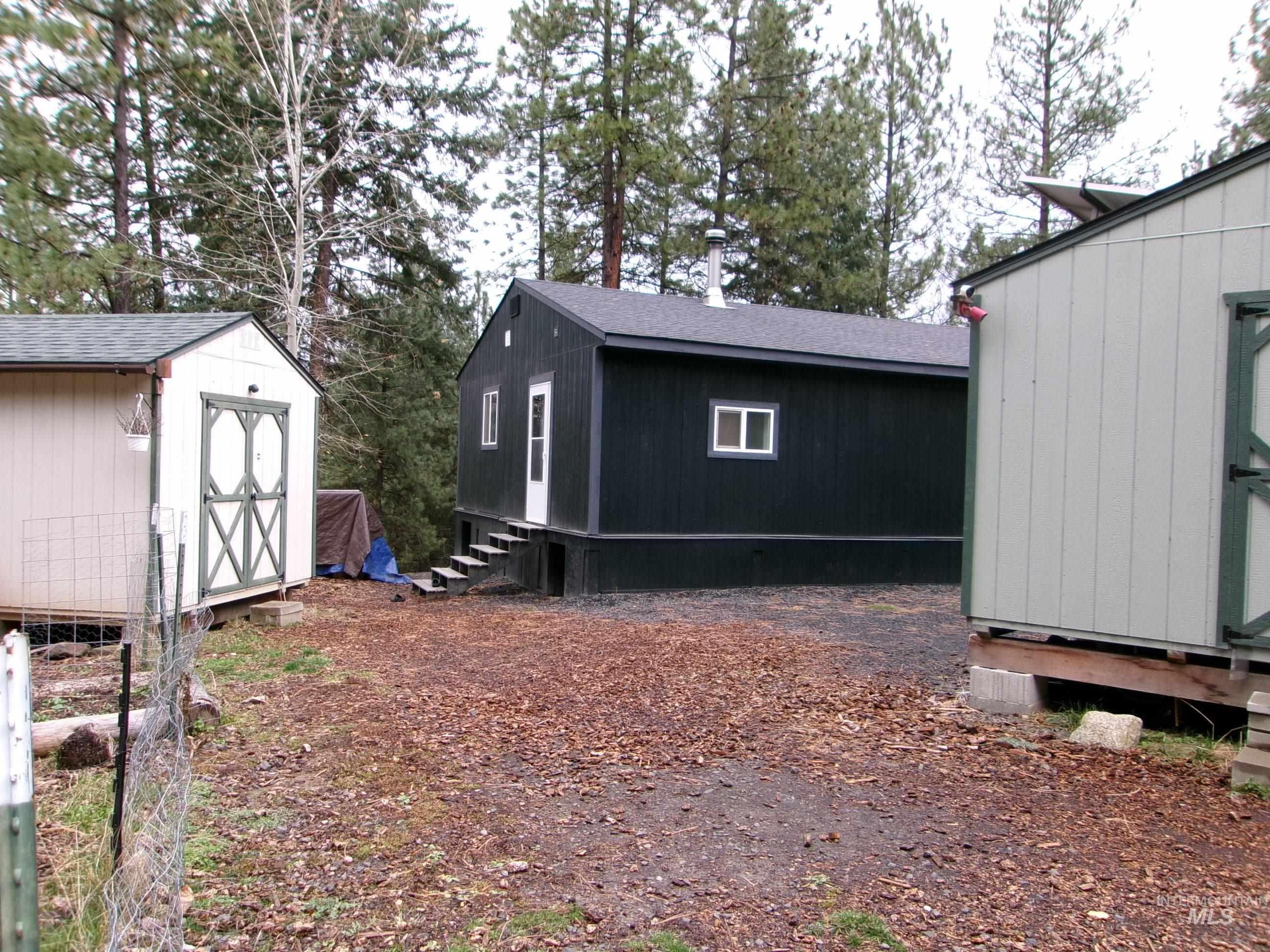 View of property exterior featuring a storage shed and entry steps