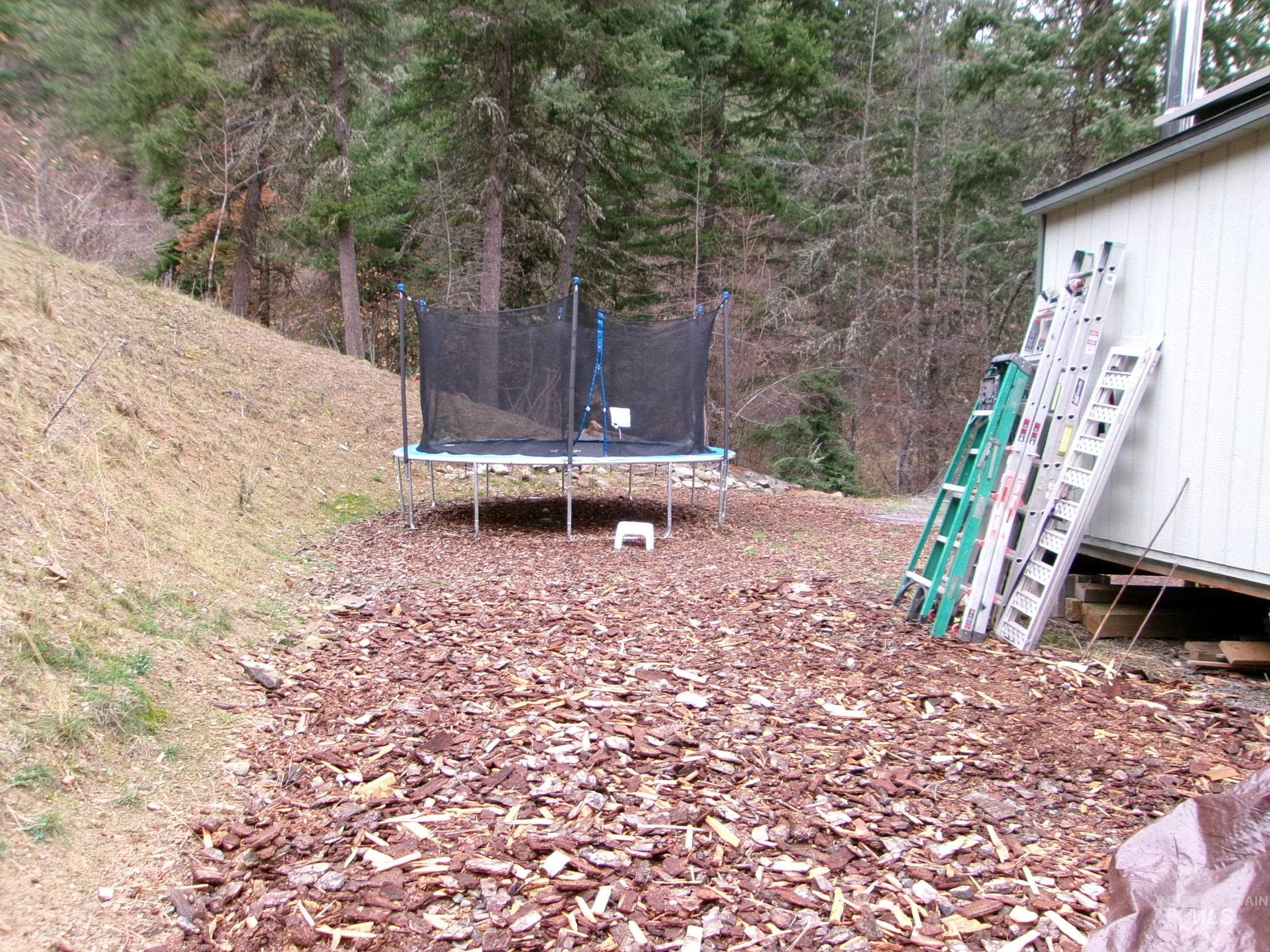 View of yard with a trampoline