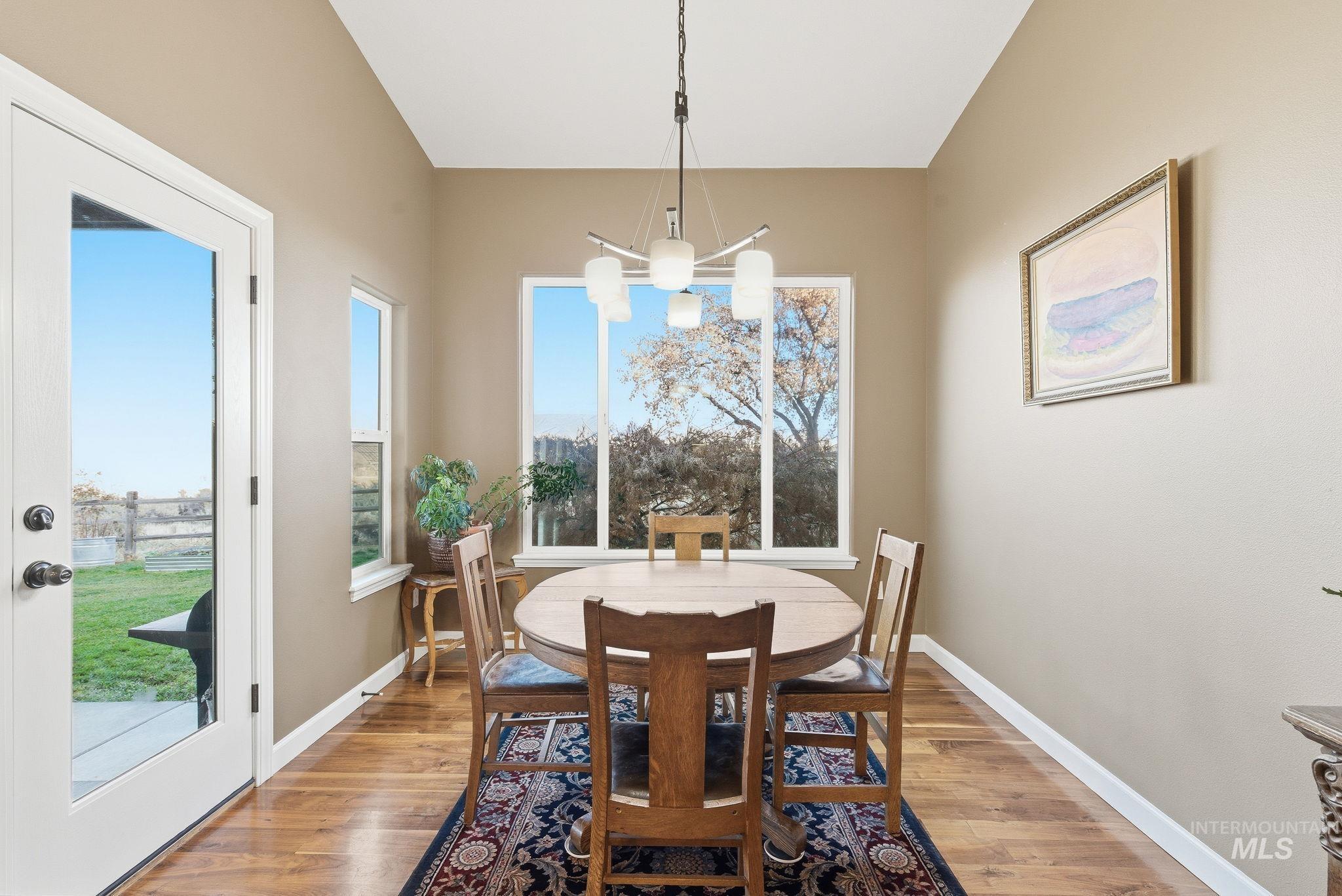 Dining room featuring light wood-type flooring and a chandelier