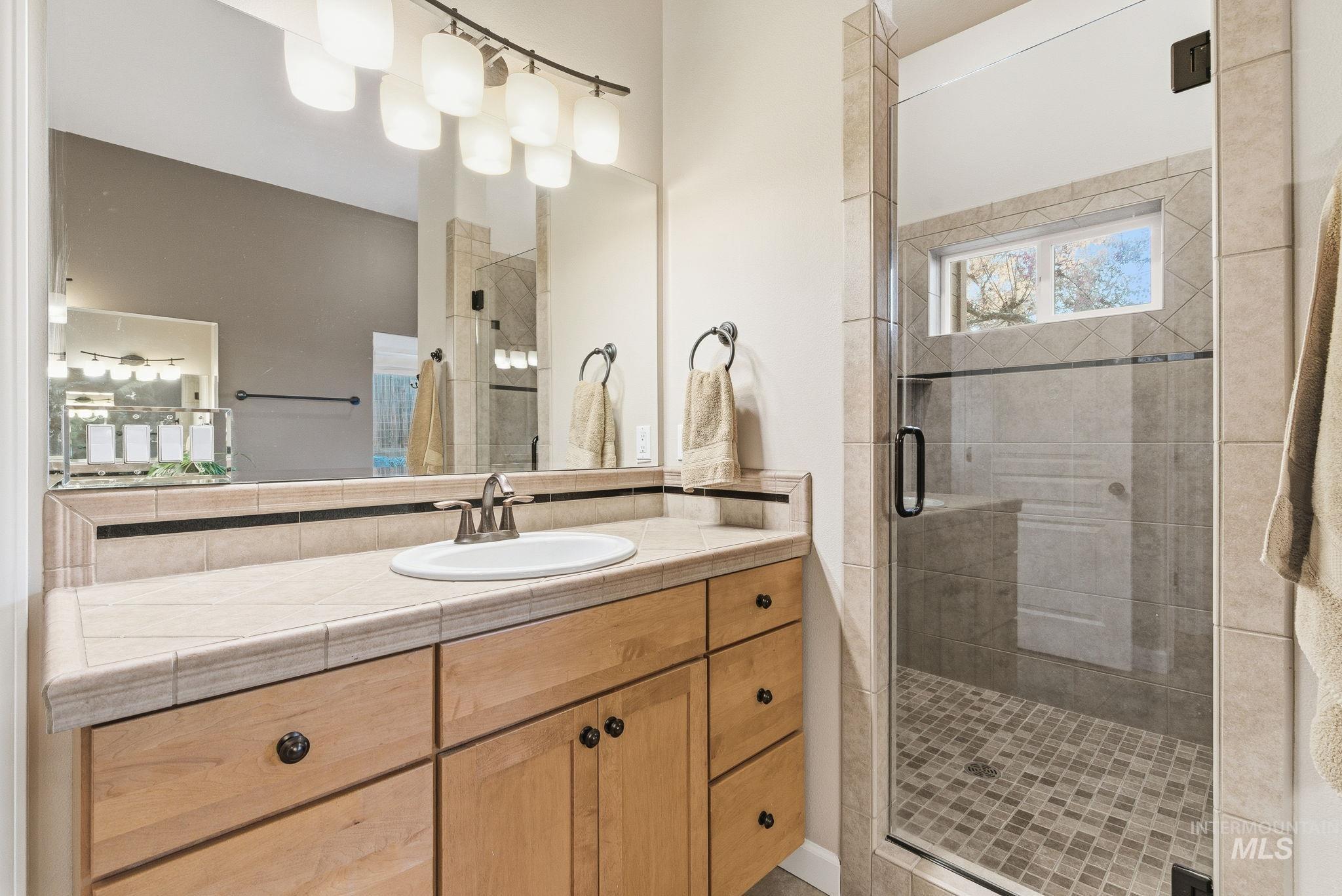Bathroom with vanity and a stall shower