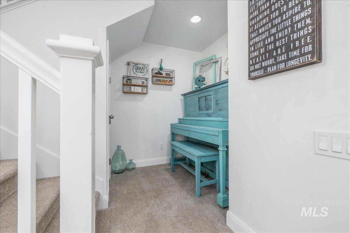 Corridor with light carpet and recessed lighting