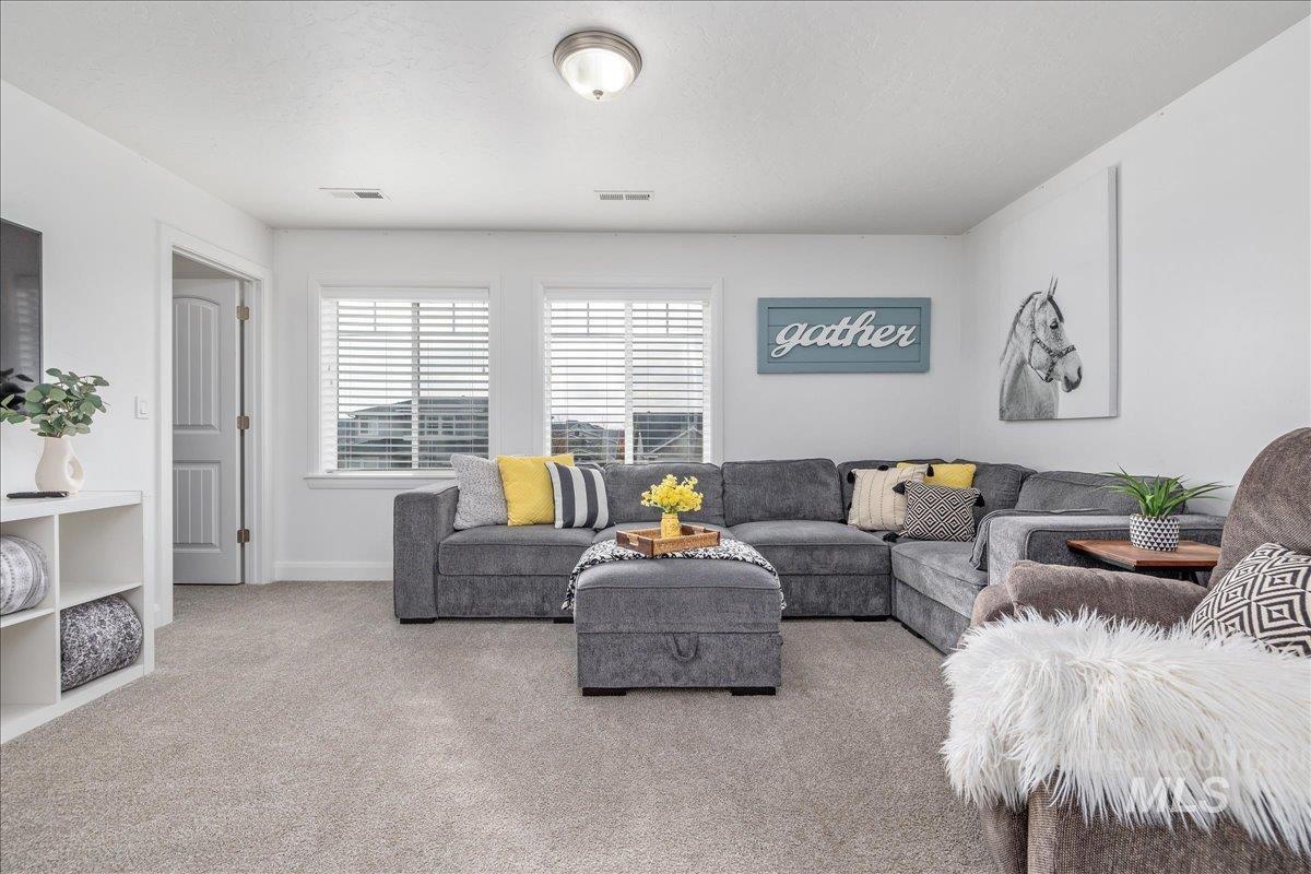 Living room featuring carpet and baseboards