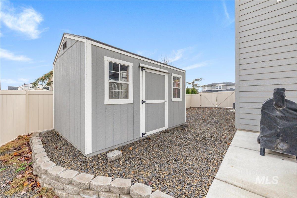 View of shed with a fenced backyard