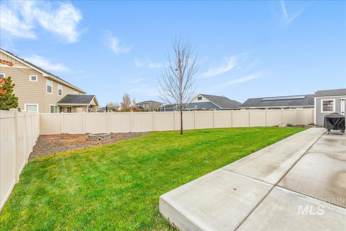 Fenced backyard featuring a residential view